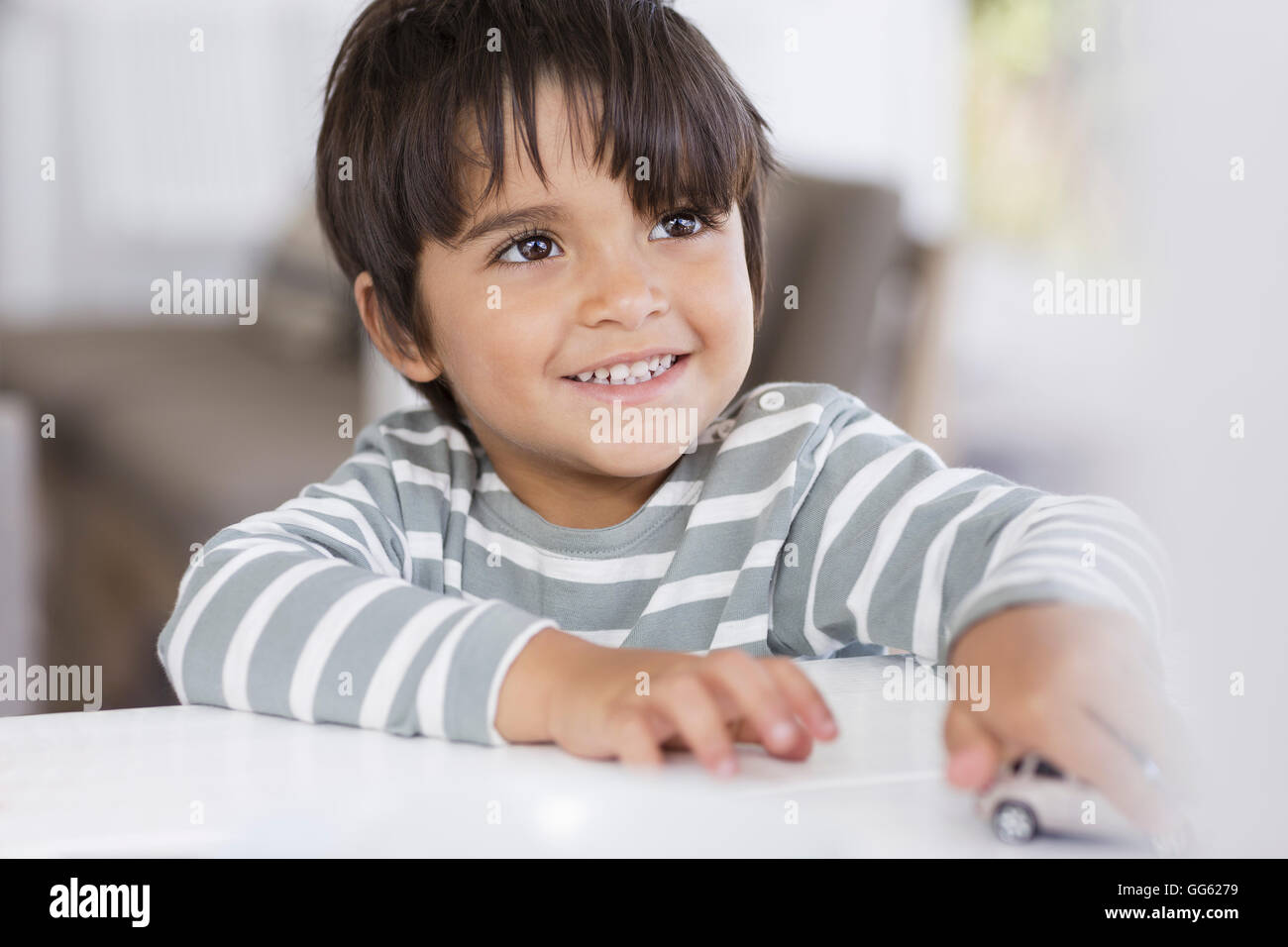 Boy playing with toy car in a living room Stock Photo - Alamy
