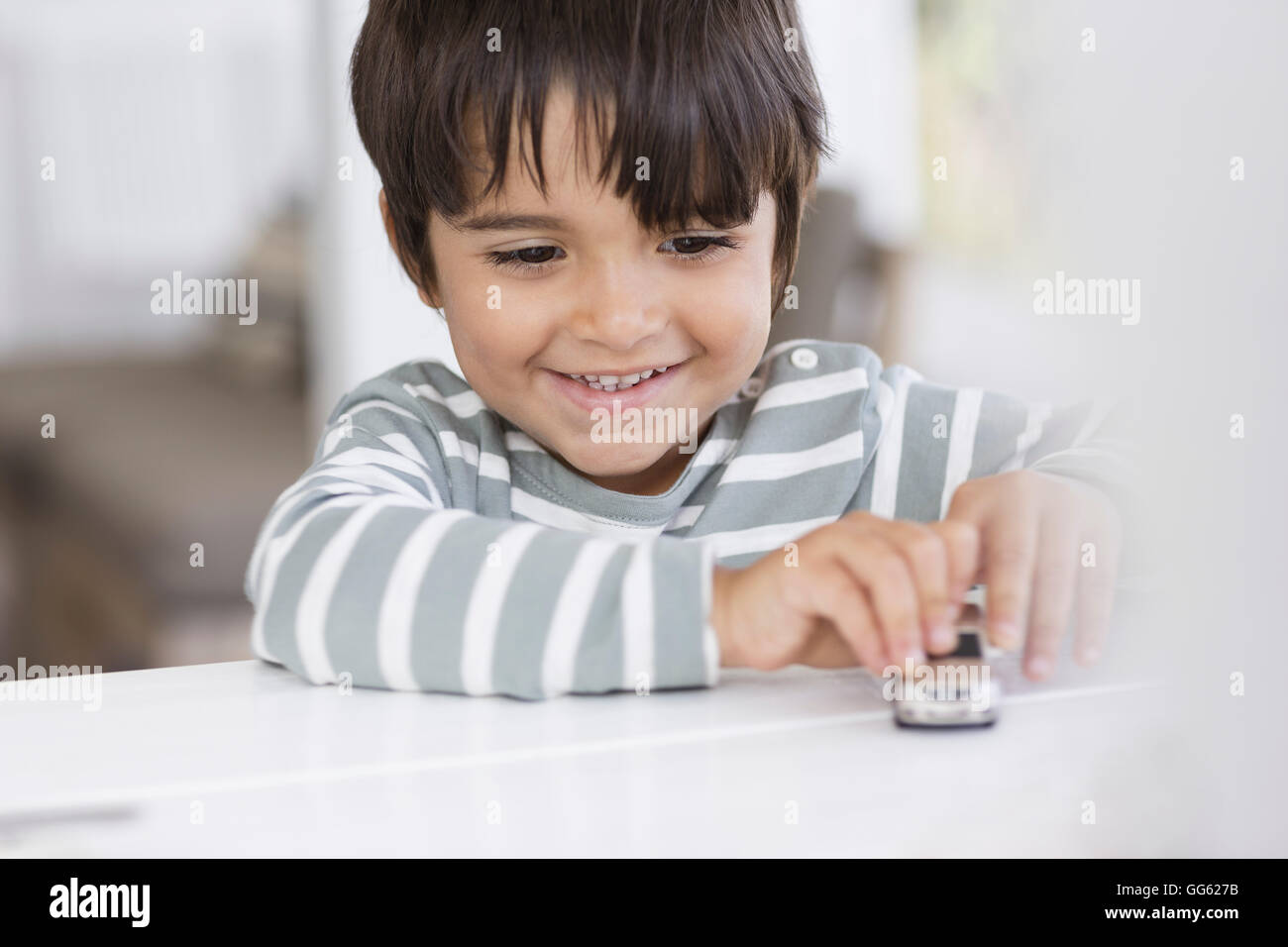 Boy playing with toy car in a living room Stock Photo - Alamy