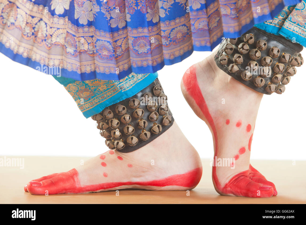 Bharatanatyam dancer's feet performing over white background Stock