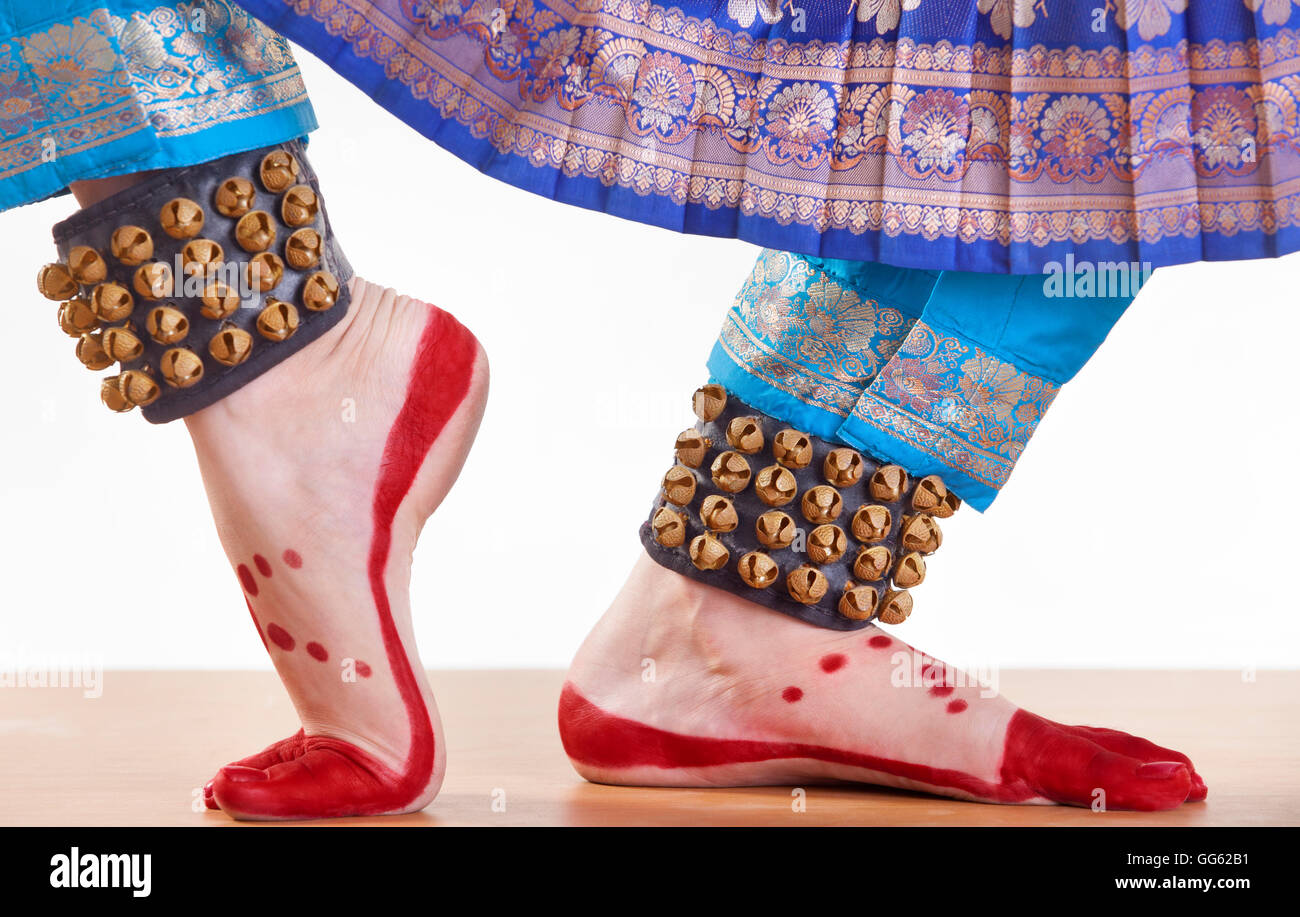 Traditional dancer's feet performing Bharatanatyam over white background Stock Photo