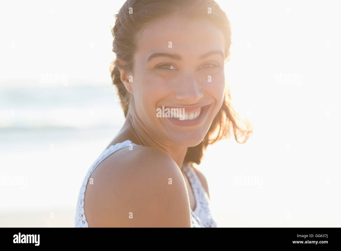 Portrait of a beautiful young woman smiling on the beach Stock Photo ...