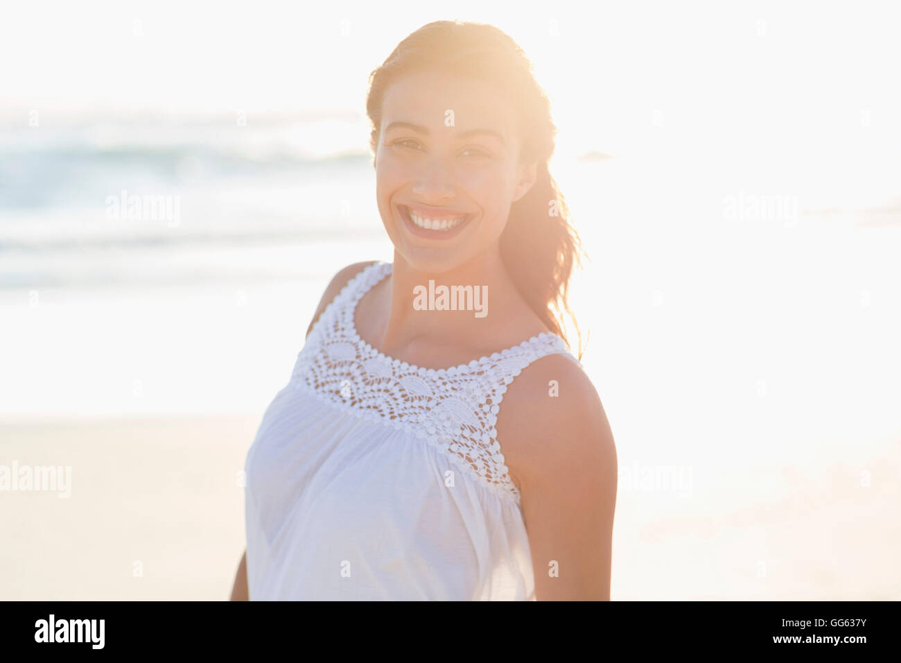 Portrait of a smiling young woman on the beach Stock Photo - Alamy