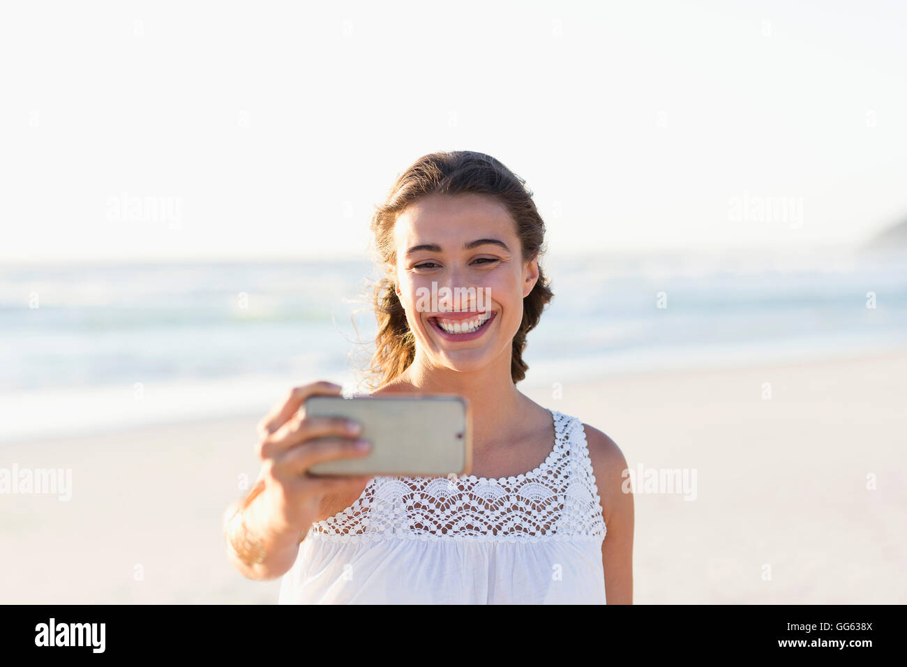 Beautiful young woman taking selfie with smartphone on the beach Stock ...