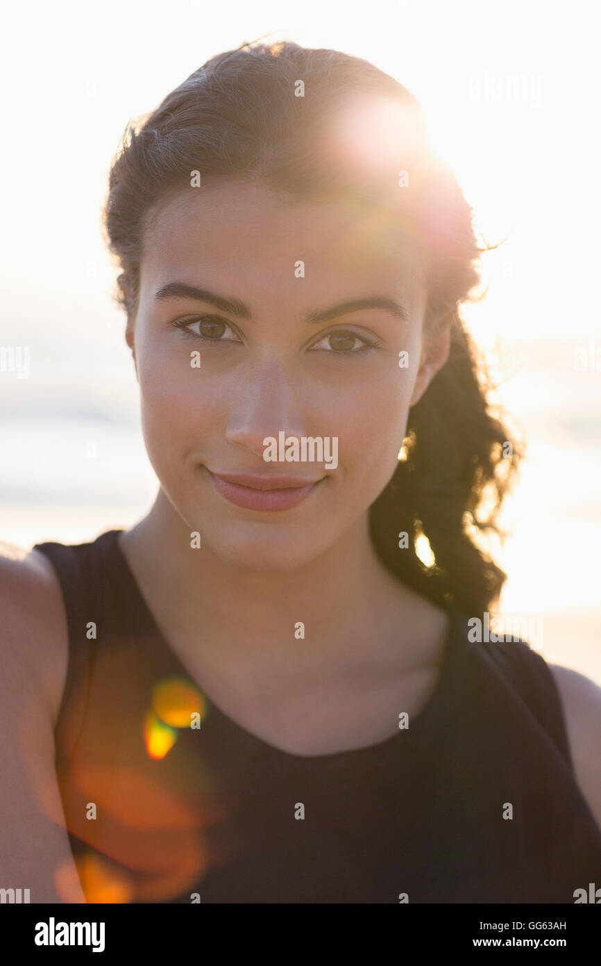Portrait of a happy young woman standing on the beach Stock Photo - Alamy
