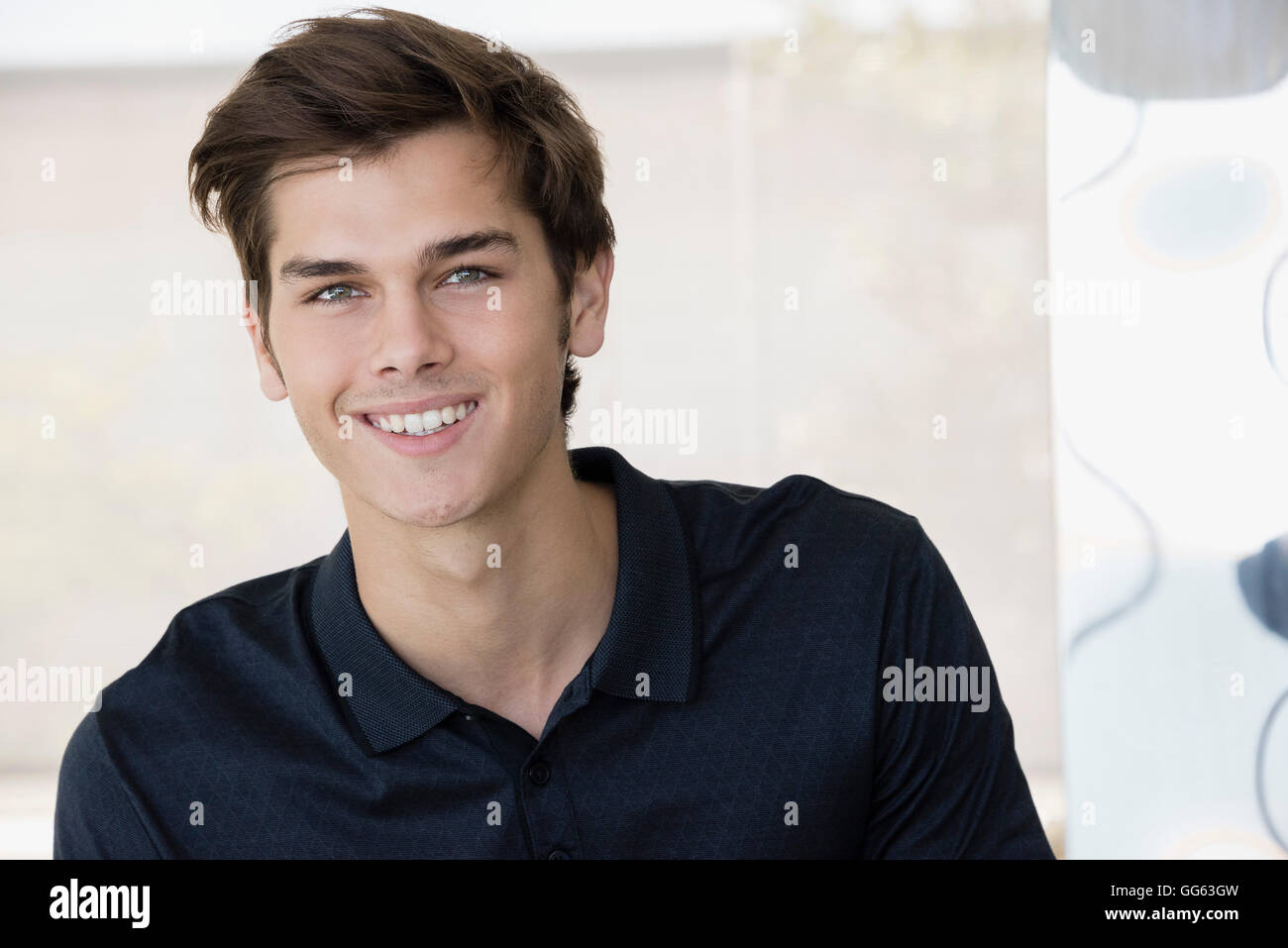Portrait of a happy young man at home Stock Photo