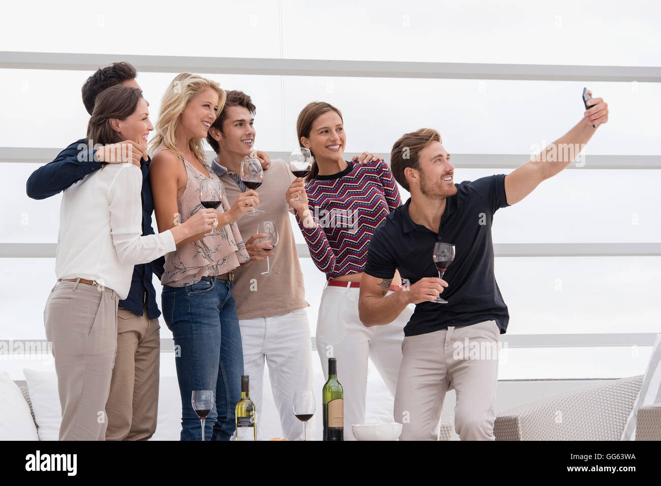 Group of friends taking selfie together at party Stock Photo - Alamy