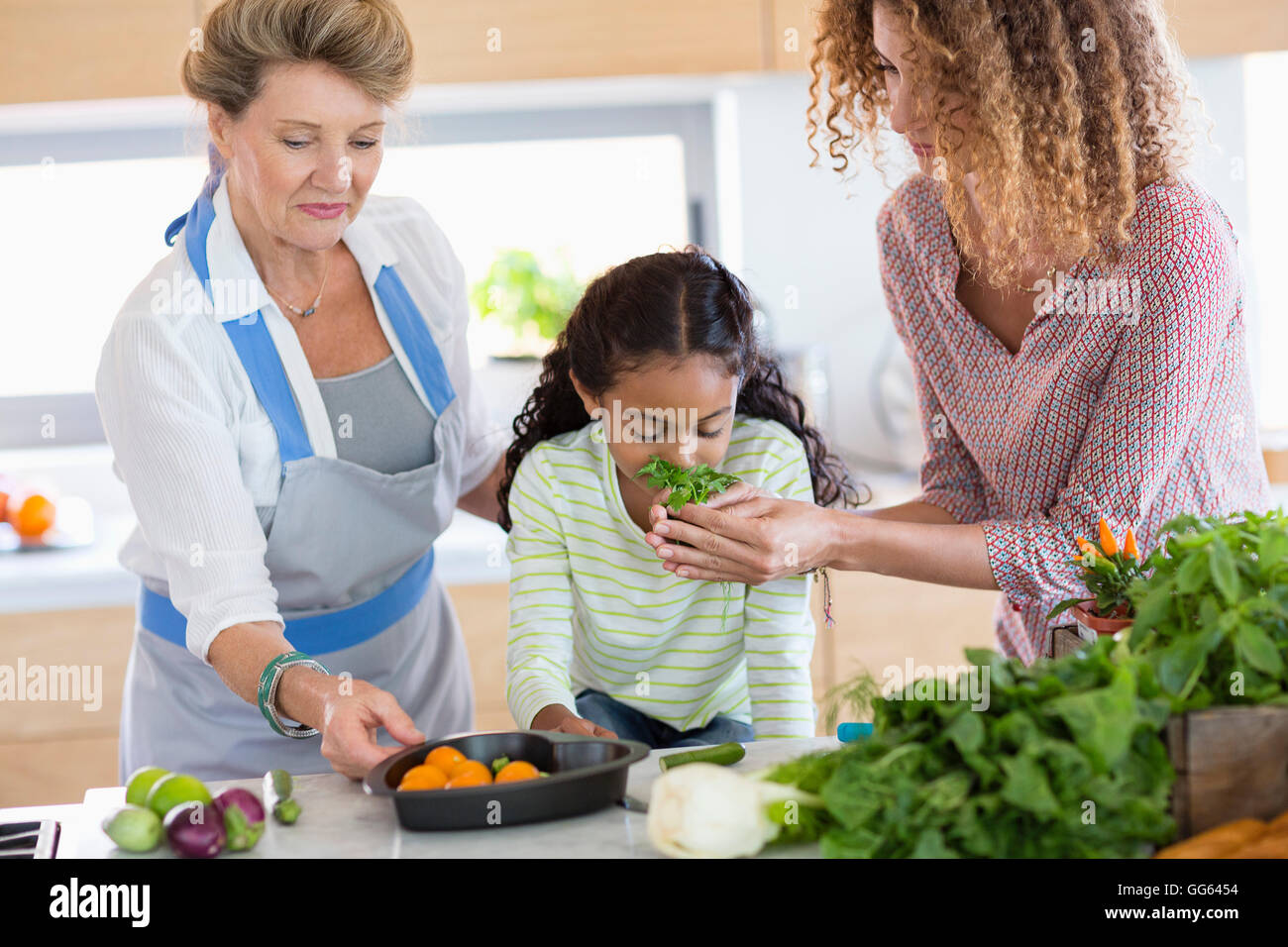 Senior woman with daughter and granddaughter in kitchen Stock Photo - Alamy