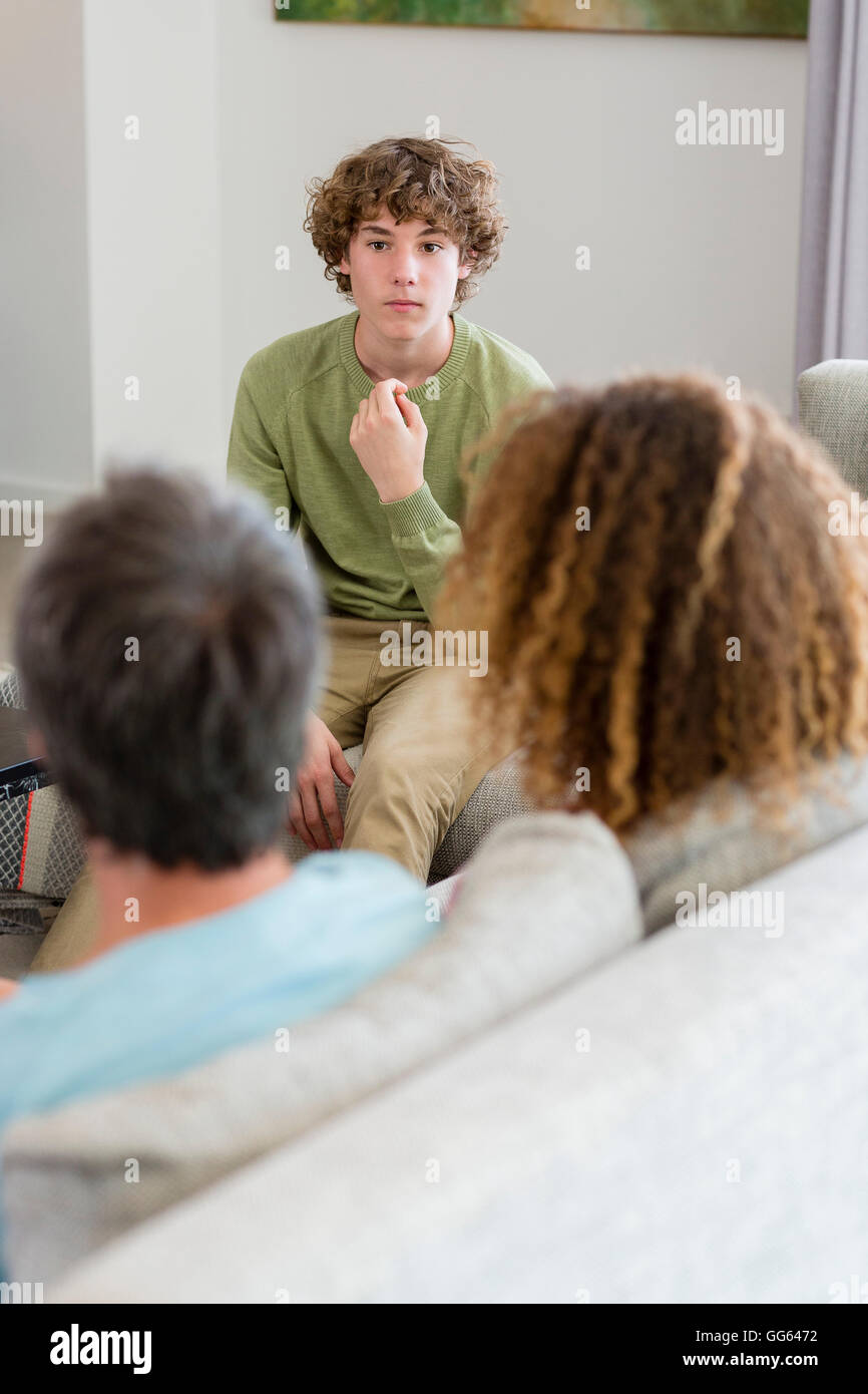 Happy family sitting in a living room at home Stock Photo