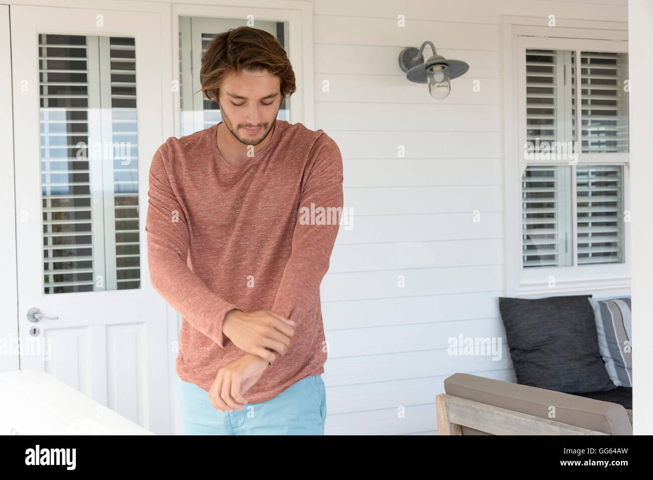 Happy young man dressing up at home Stock Photo