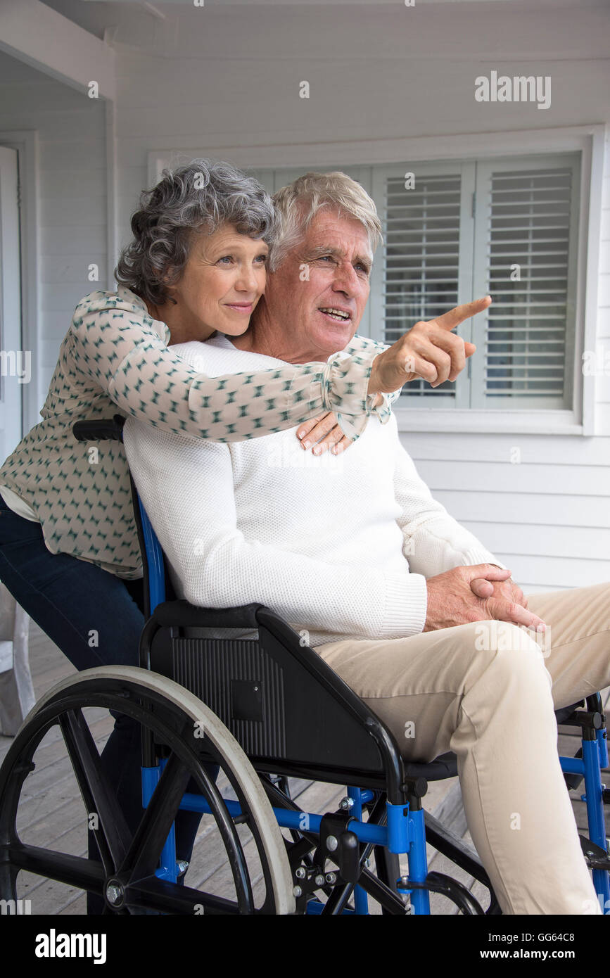 Senior man in wheelchair with his wife on porch Stock Photo Alamy