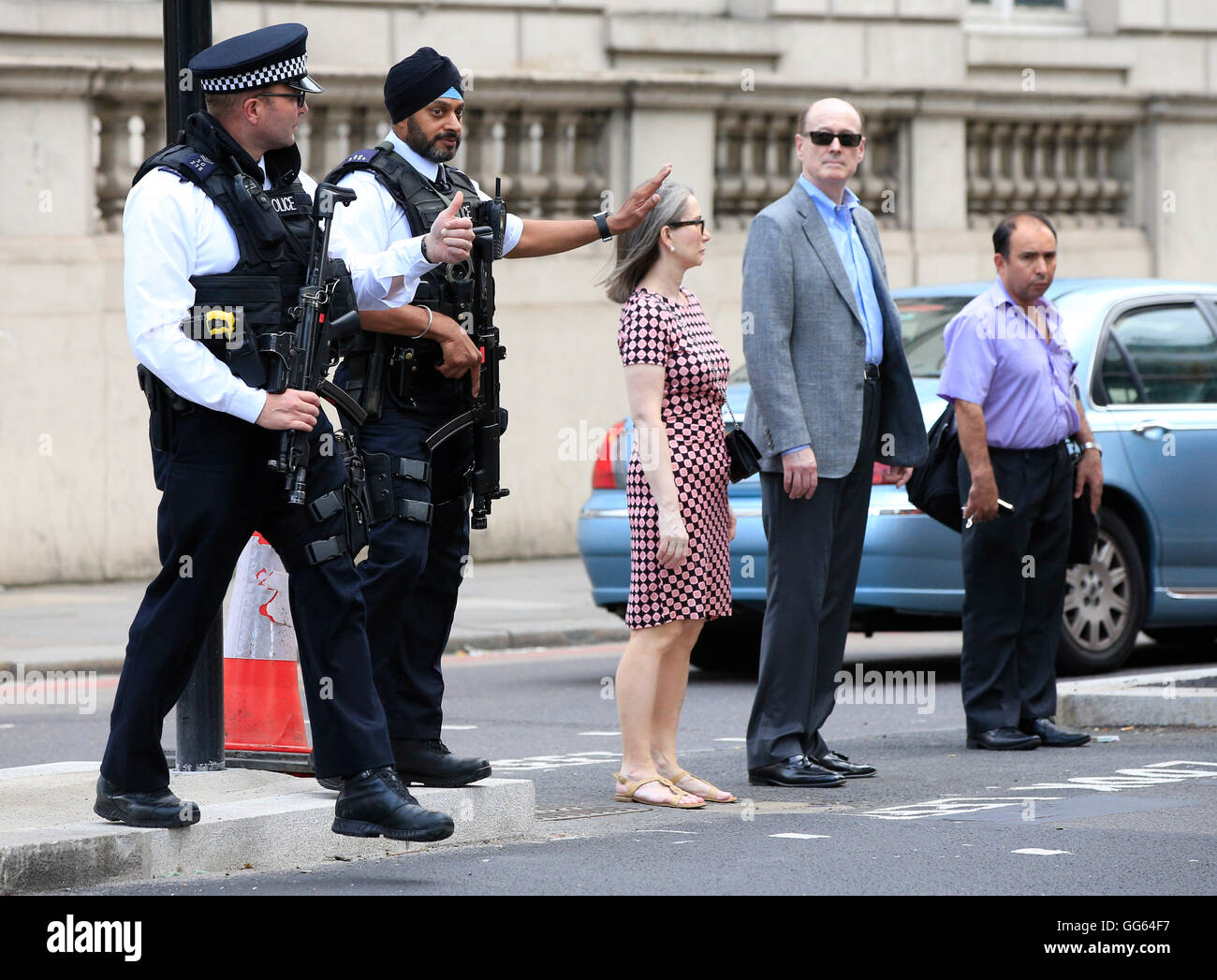 Armed police patrol as part of a security operation near the junction of Knightsbridge and Hyde Park Corner, London, as Scotland Yard announced that the first of 600 additional armed officers were trained and operationally ready, and unveiled plans to put more marksmen on public patrol. Stock Photo