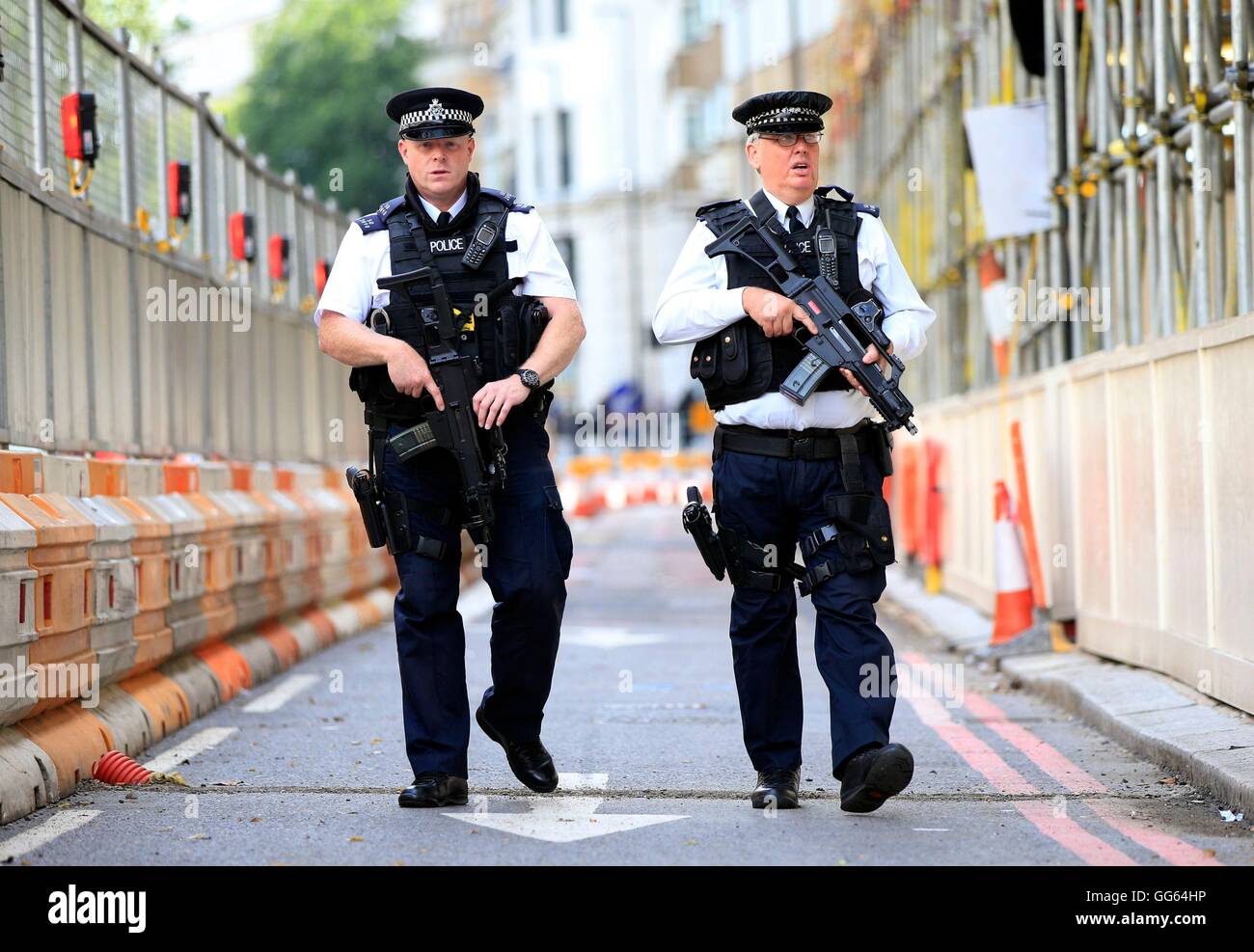Armed police patrol as part of a security operation near the junction of Knightsbridge and Hyde Park Corner, London, as Scotland Yard announced that the first of 600 additional armed officers were trained and operationally ready, and unveiled plans to put more marksmen on public patrol. Stock Photo