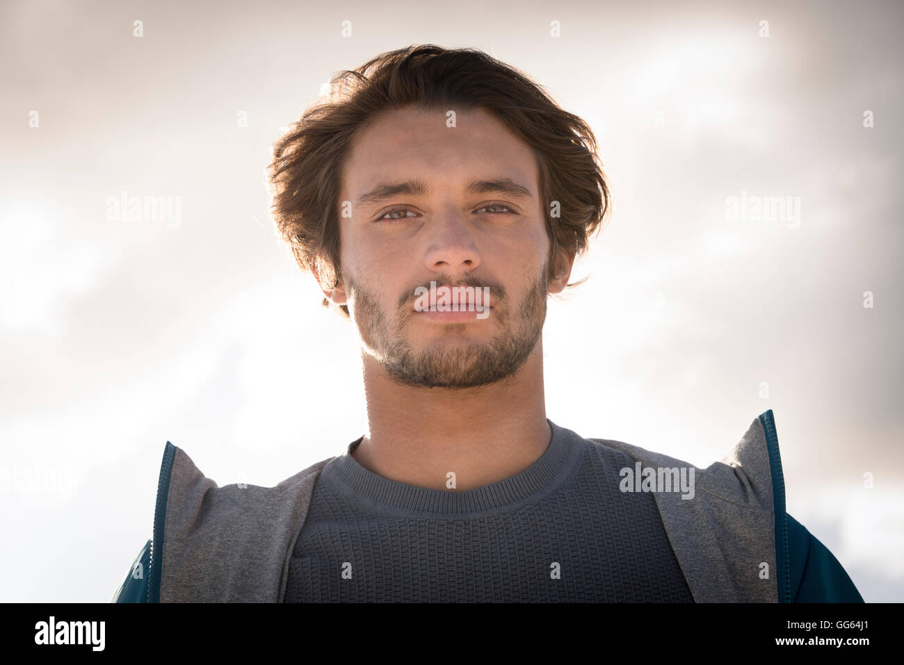 Portrait of a young man against cloudy sky Stock Photo - Alamy