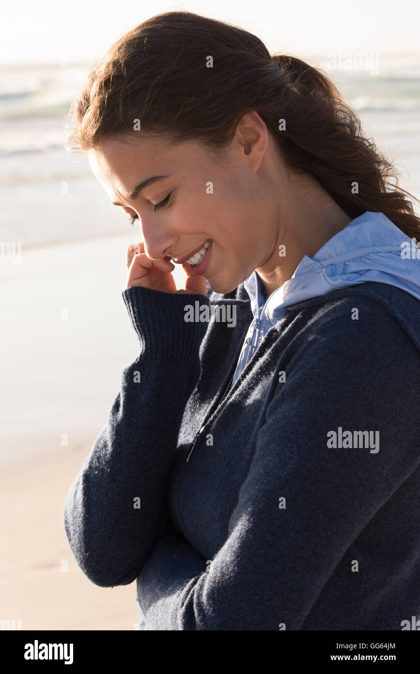 Happy woman standing on the beach Stock Photo - Alamy