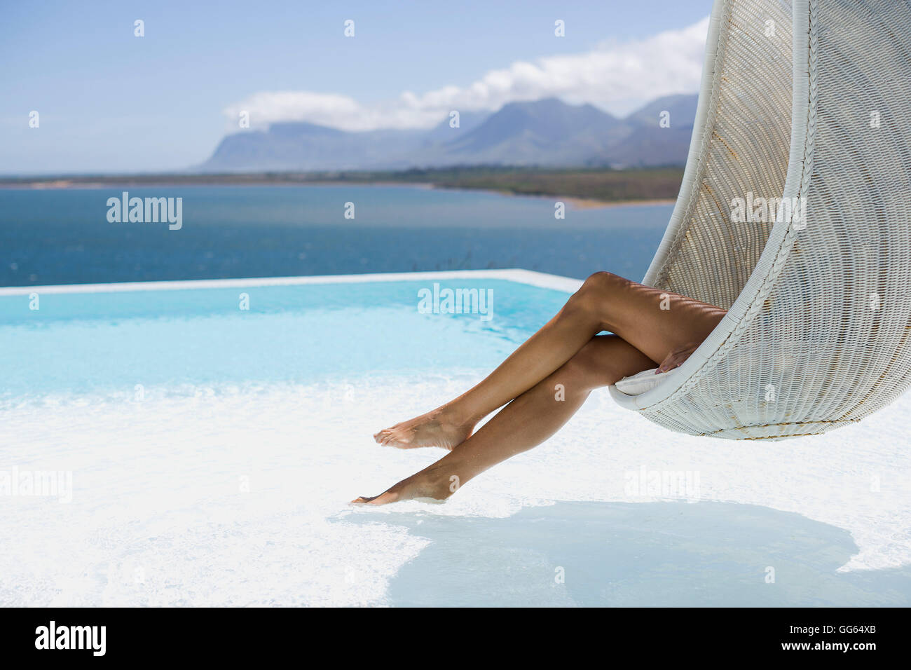 Low section view of a woman relaxing in wicker swing Stock Photo - Alamy