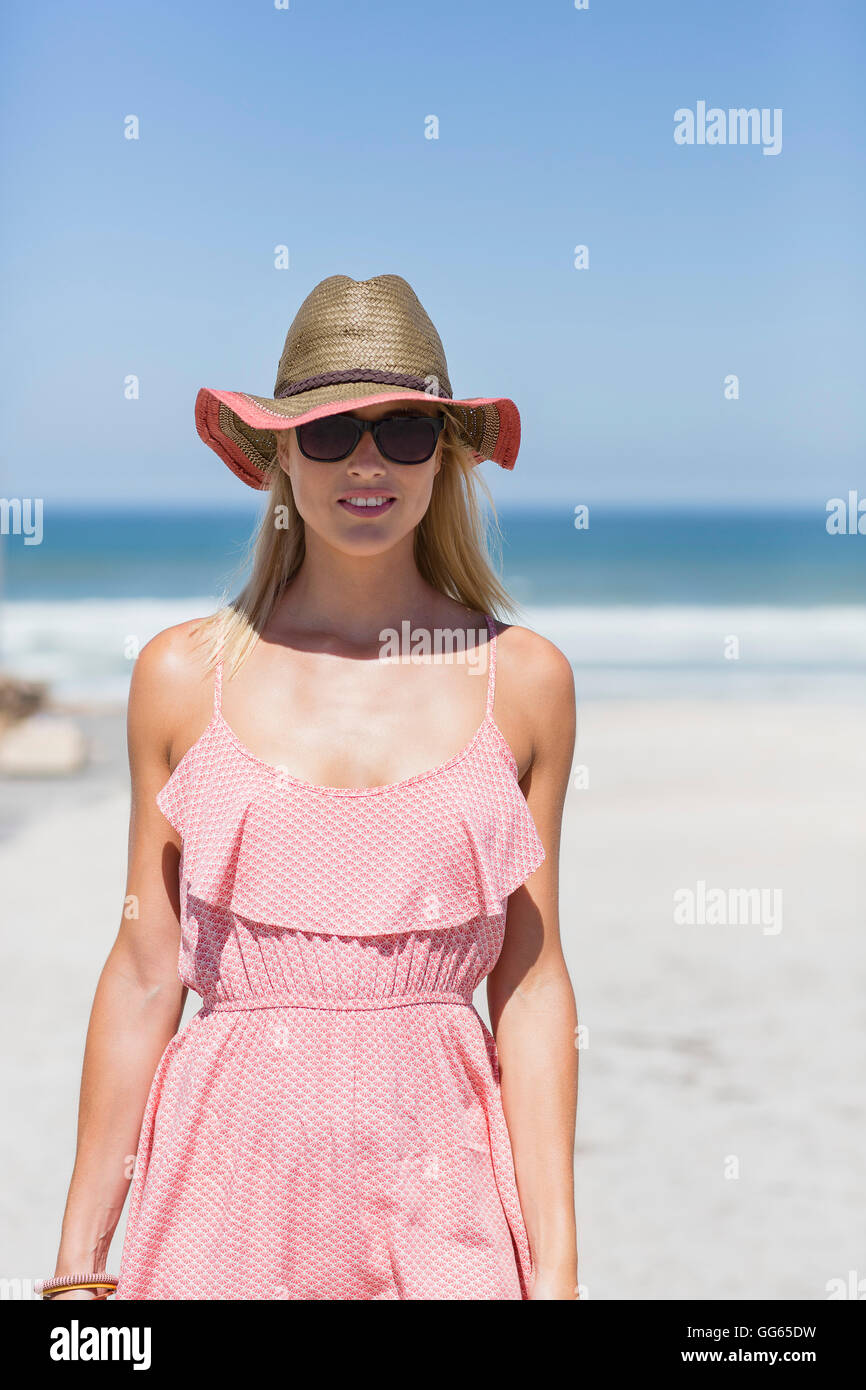 Woman standing on sunny beach hi-res stock photography and images - Alamy