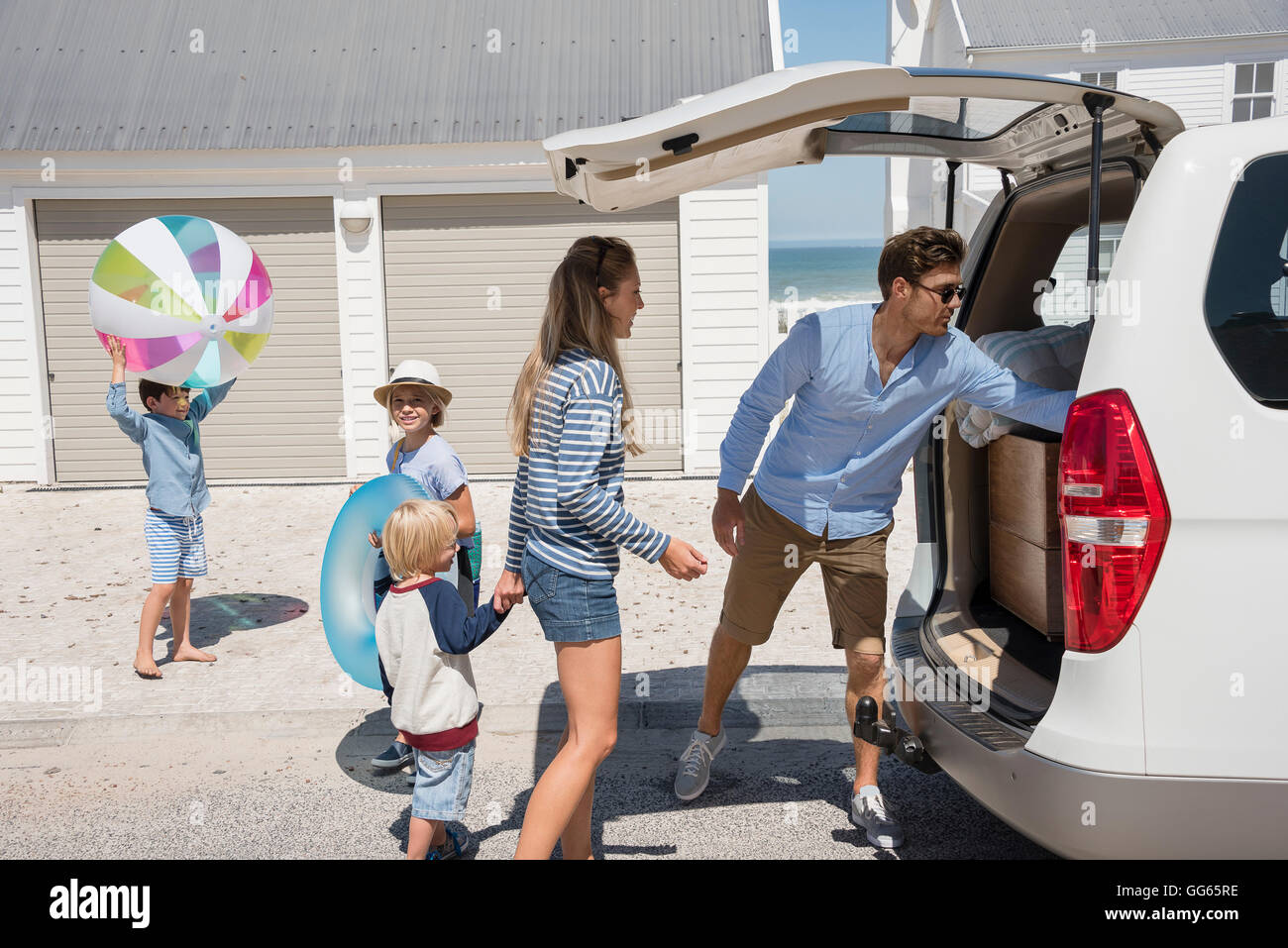 Young family packing car with beach gears for vacation Stock Photo Alamy