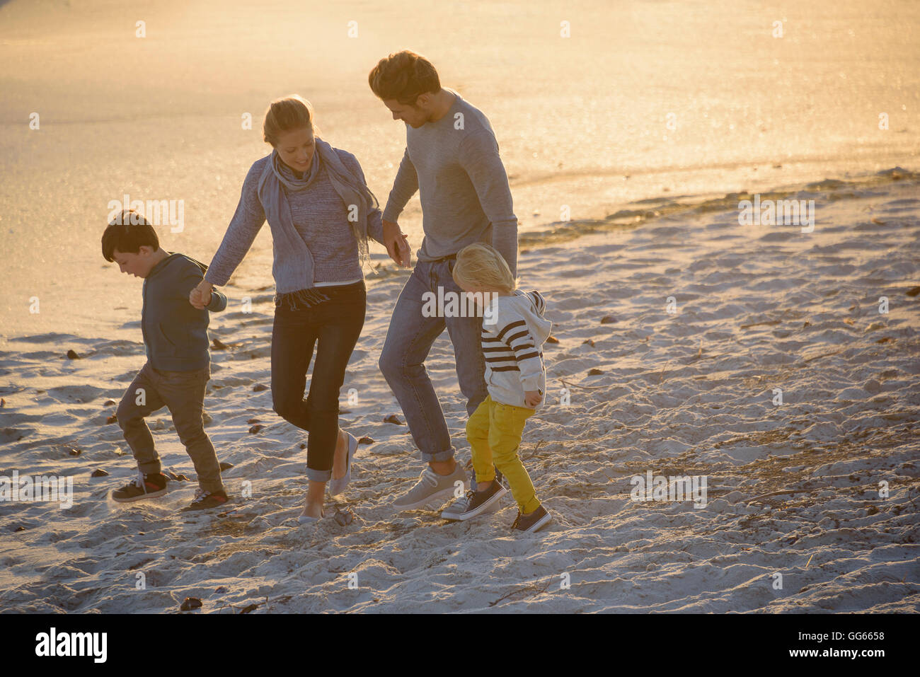 Family on beach at dusk hi-res stock photography and images - Alamy