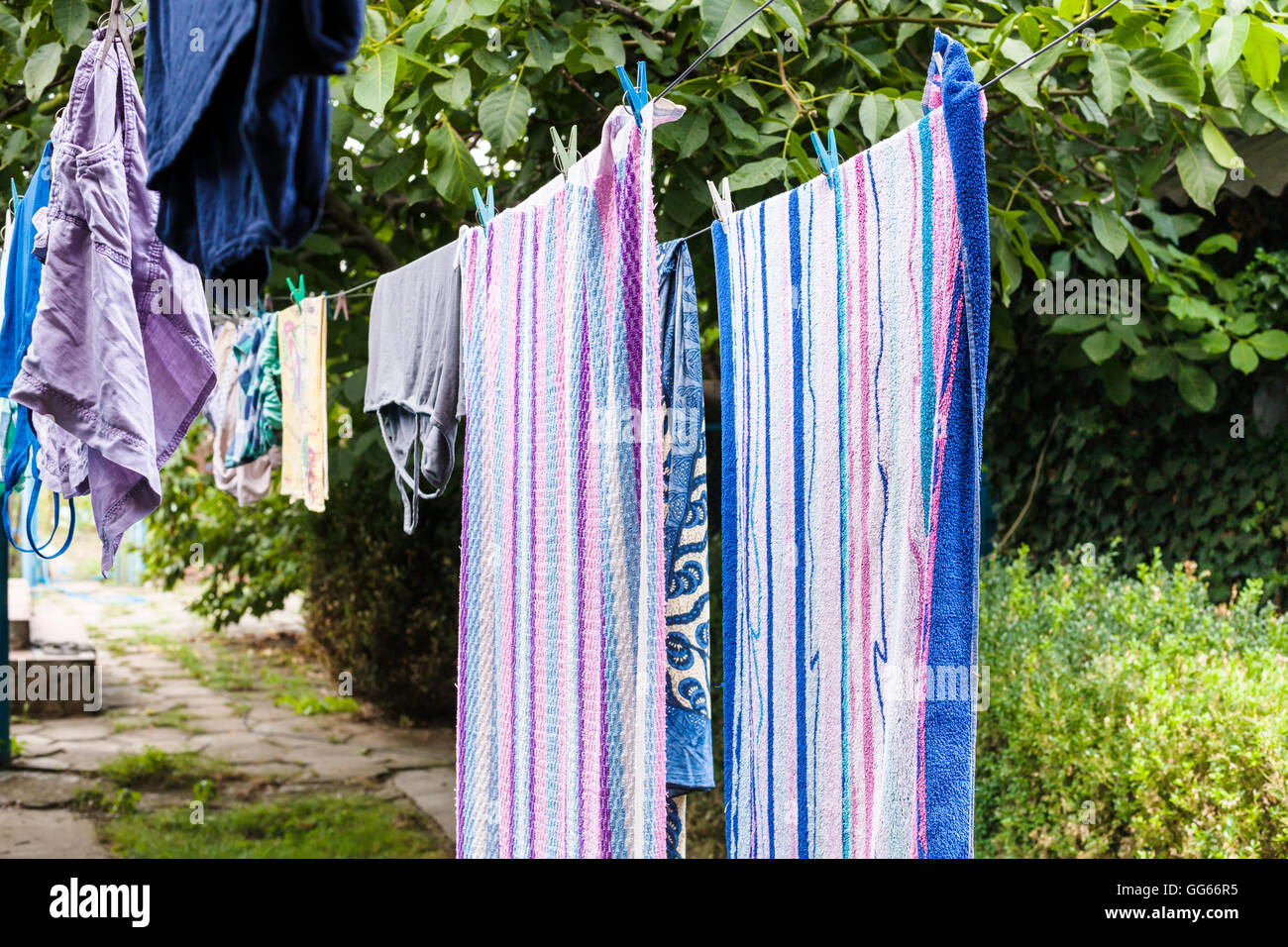 towels and linen drying in the courtyard in open air in summer day