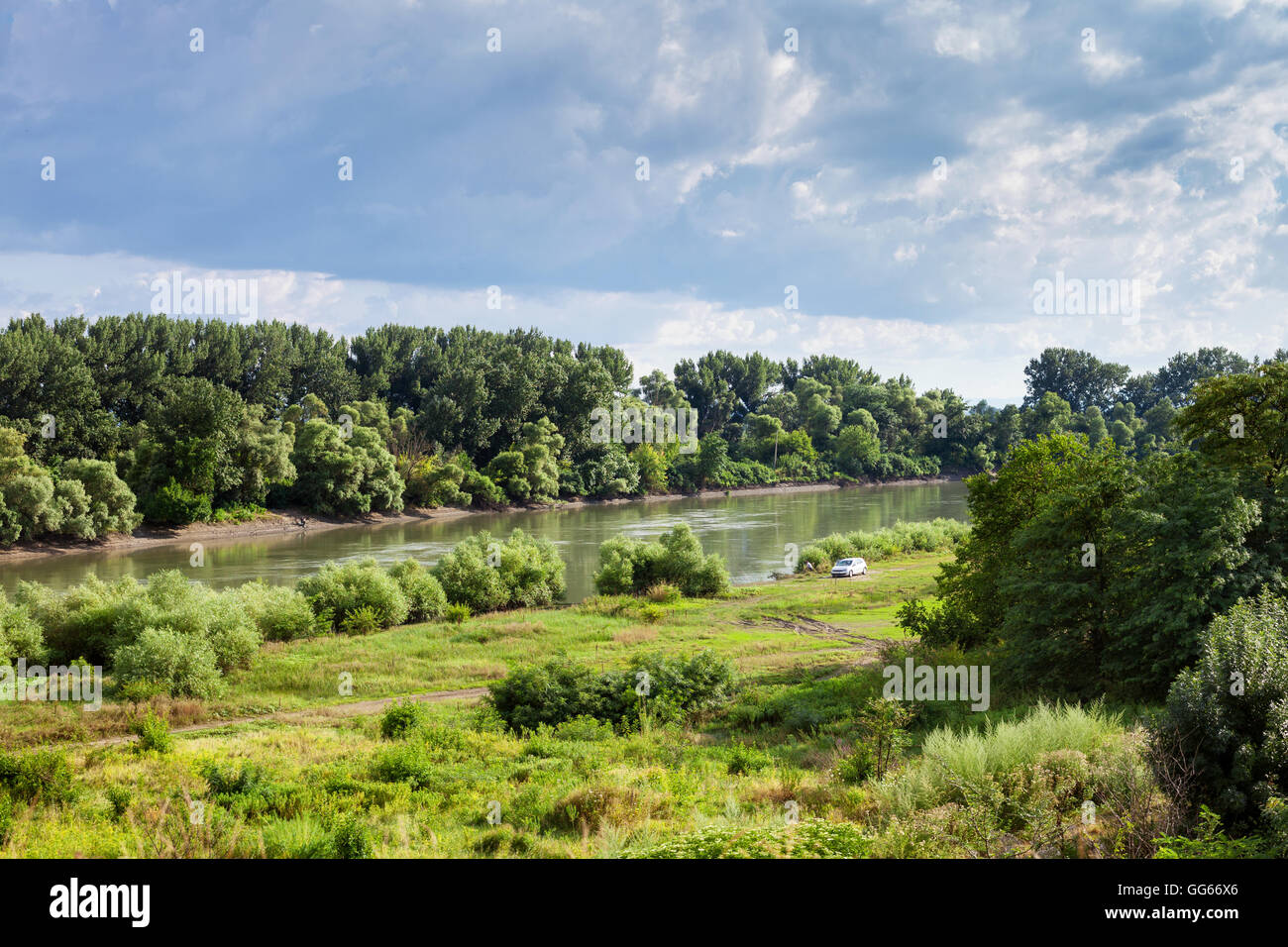 green meadow along Kuban river in summer day before rain near Slavyansk-na-Kubani town, Caucasus, Russia Stock Photo