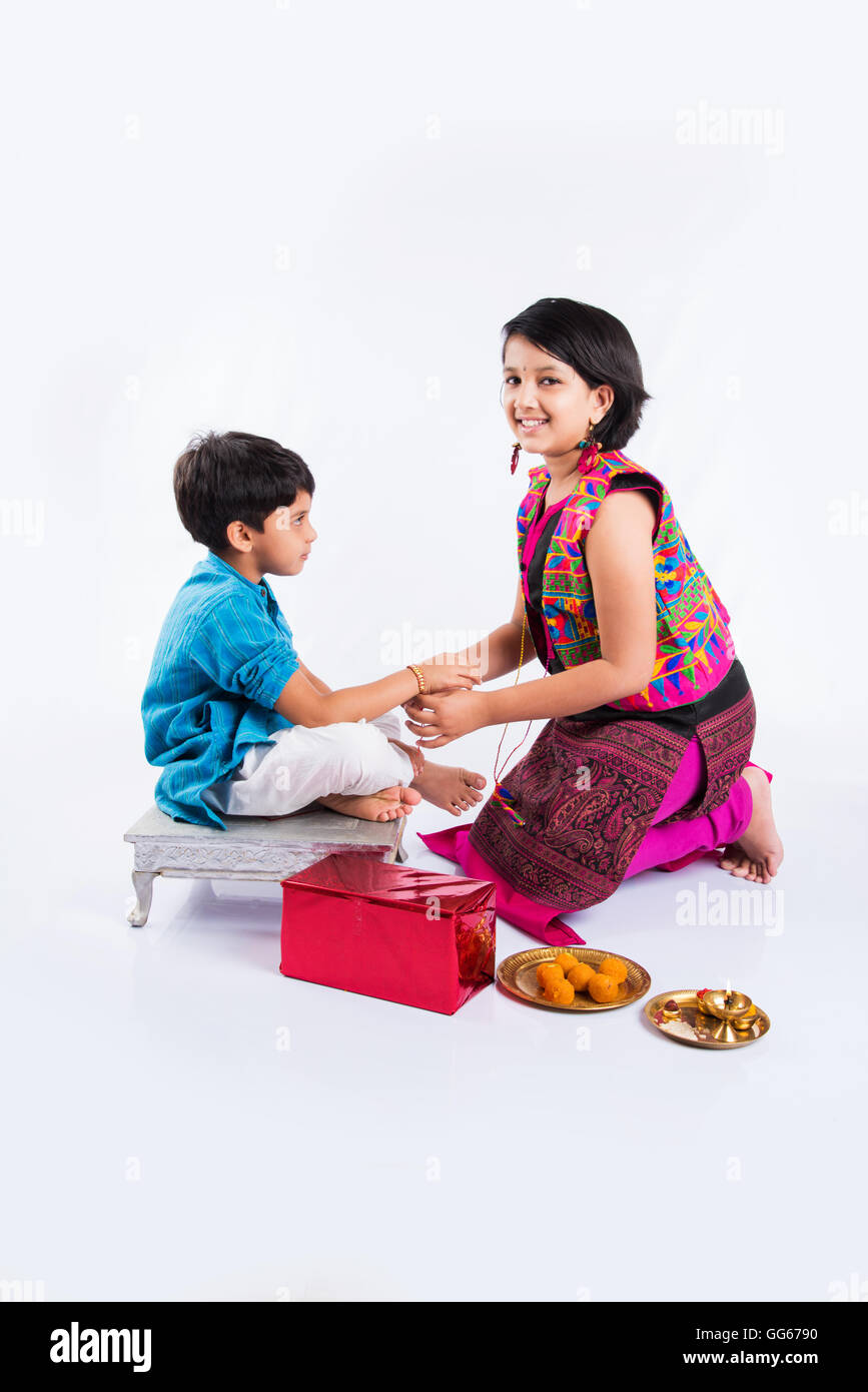 cute indian Sister tying Rakhi on her brother's wrist on the ...