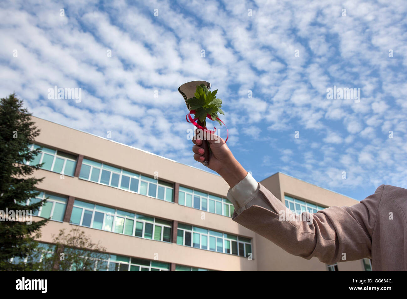 School bell ringing in hand of a woman for the back to school day. Stock Photo