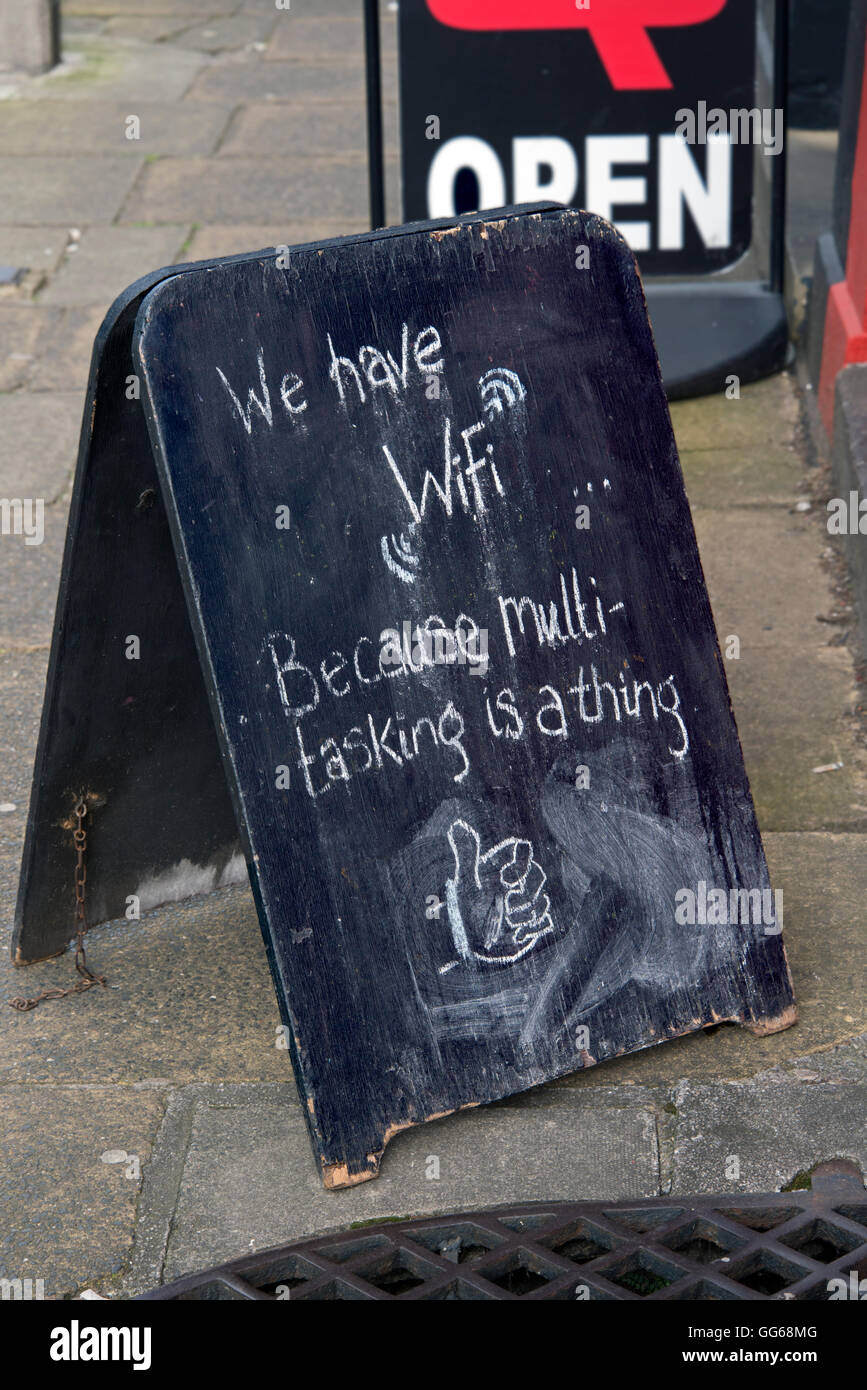 A witty chalk sign outside  a café in Barony Street, Edinburgh promoting WiFi and multi-tasking. Stock Photo