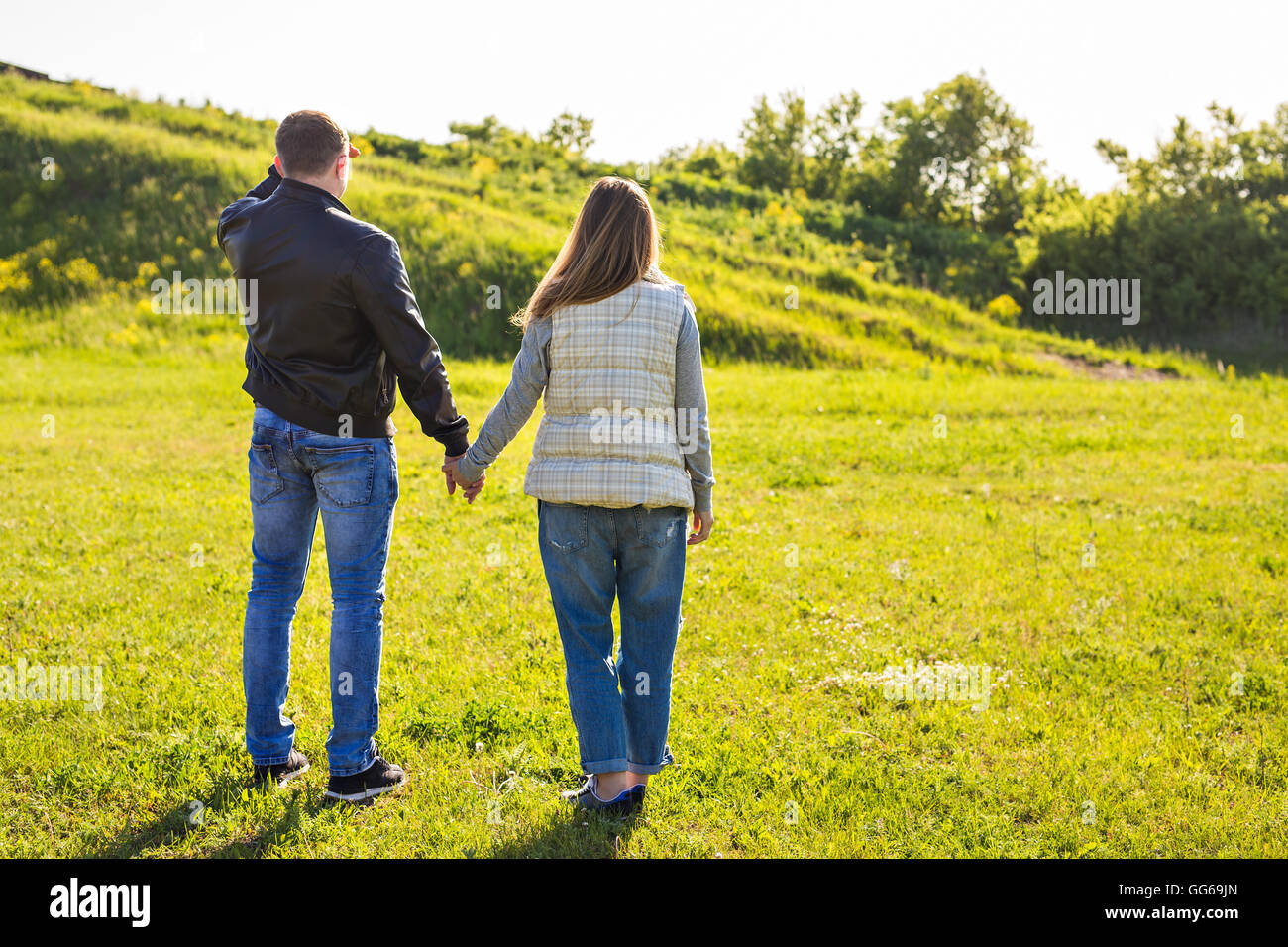 rear view of couple holding hands walking in autumn countryside Stock ...