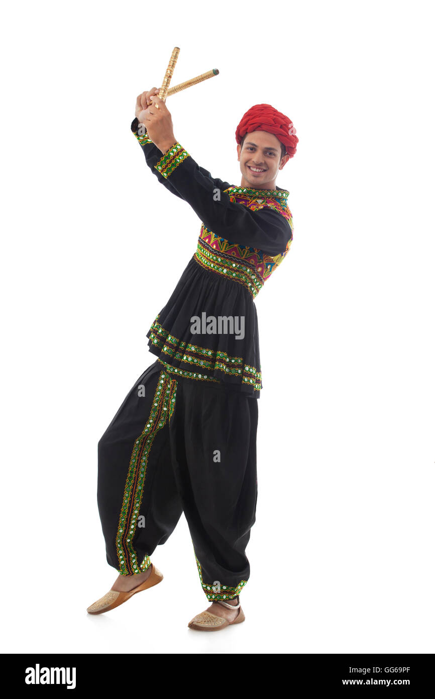 Portrait of a male dandiya dancer with sticks Stock Photo - Alamy