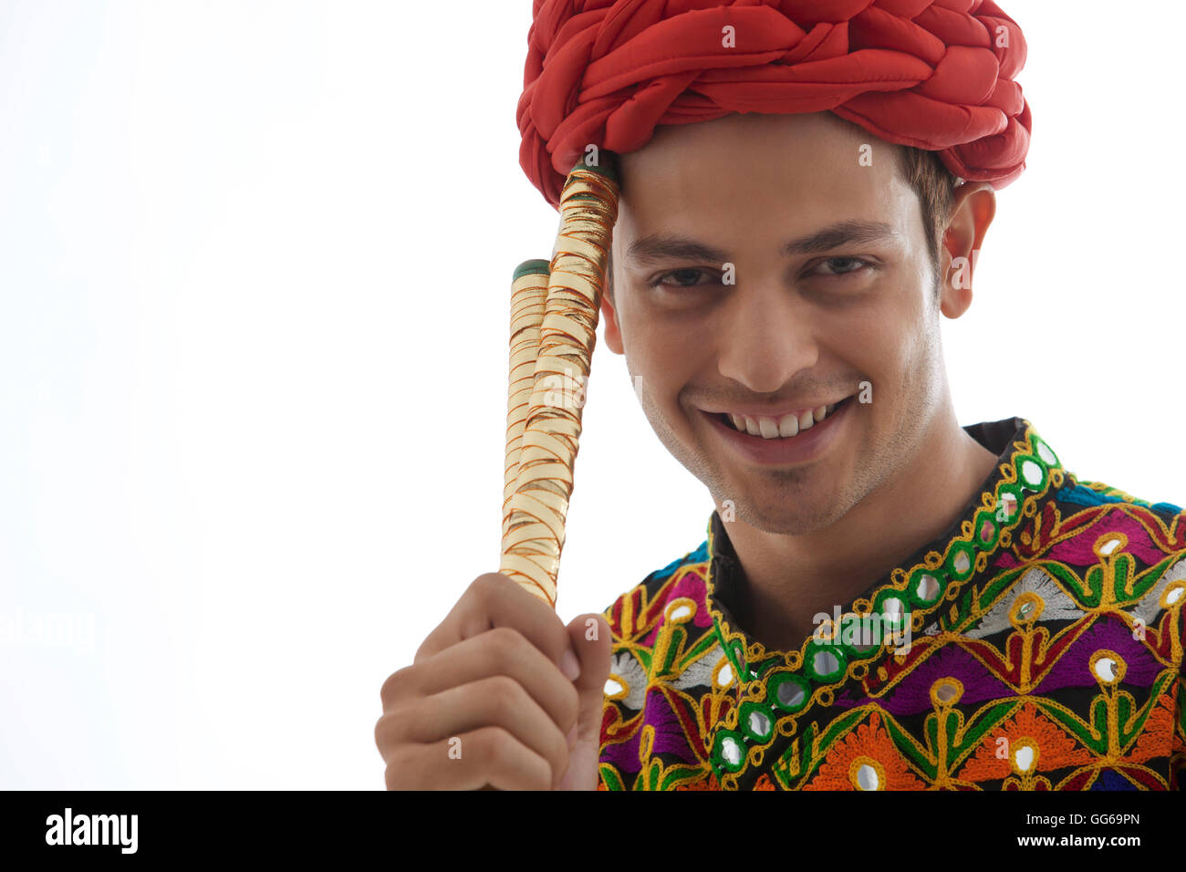 Portrait of a male dandiya dancer with sticks Stock Photo - Alamy