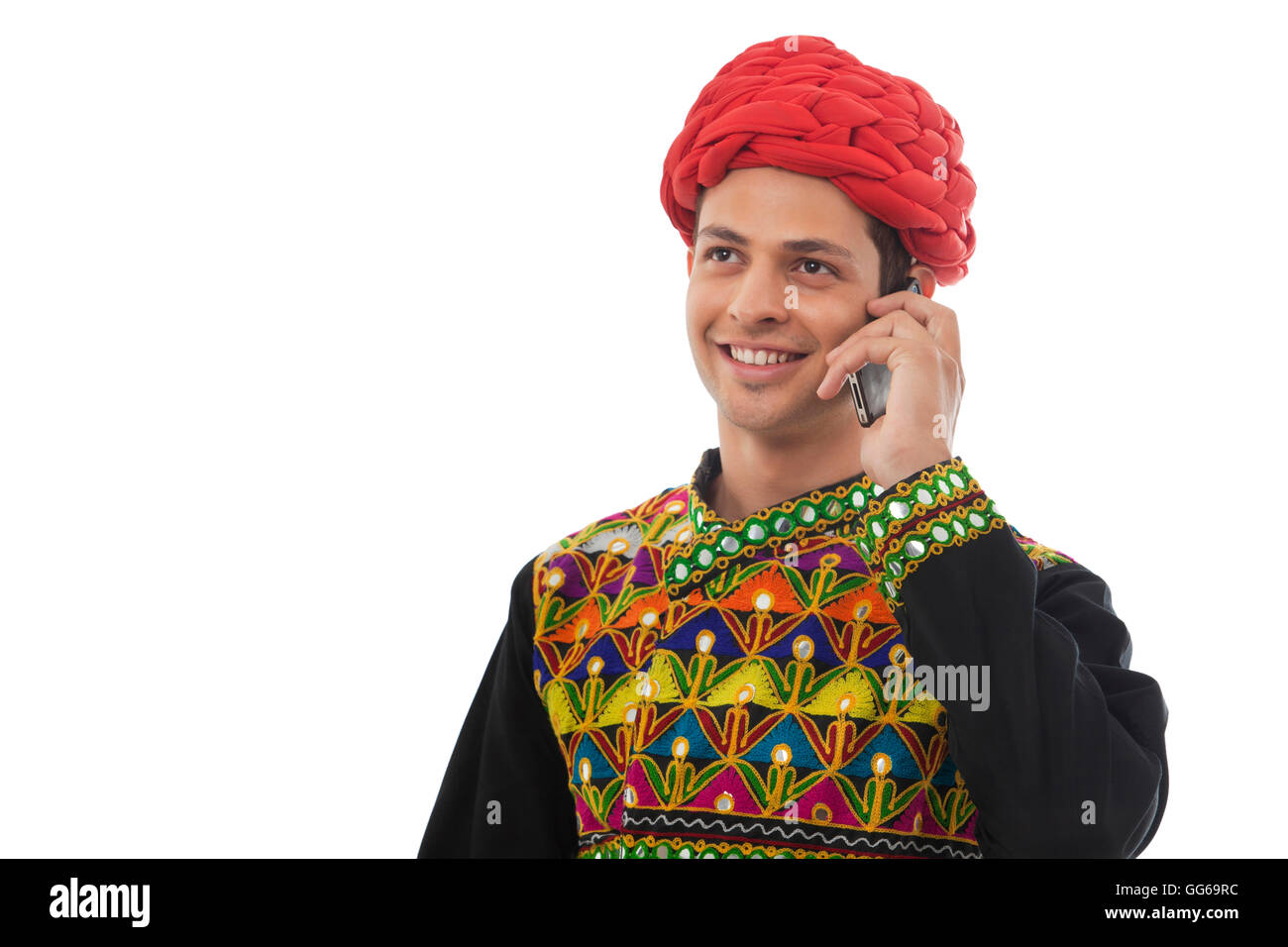 Male dandiya dancer talking on a mobile phone Stock Photo - Alamy