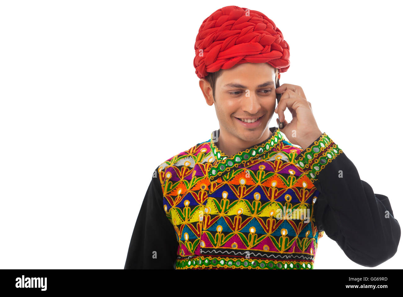 Male dandiya dancer talking on a mobile phone Stock Photo - Alamy