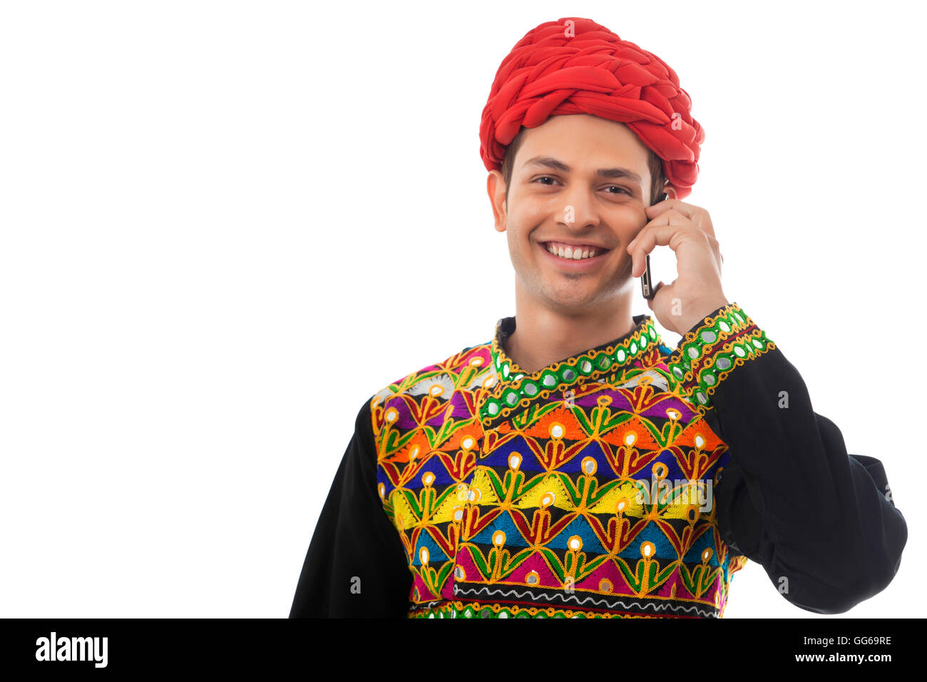 Male dandiya dancer talking on a mobile phone Stock Photo - Alamy