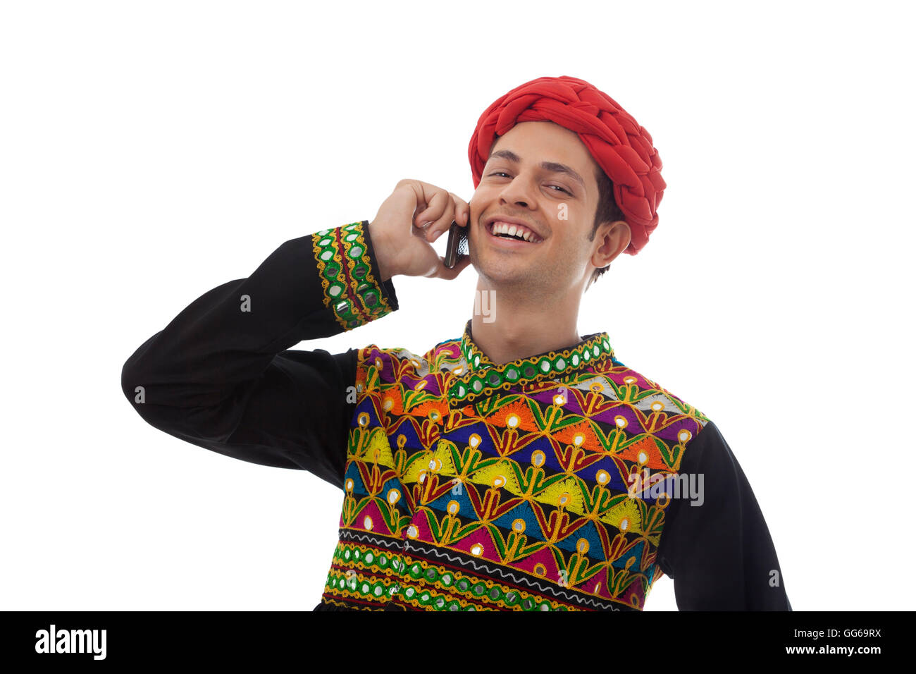 Male dandiya dancer talking on a mobile phone Stock Photo - Alamy