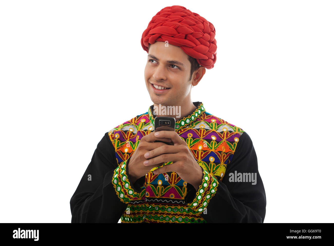 Male dandiya dancer with a mobile phone Stock Photo - Alamy