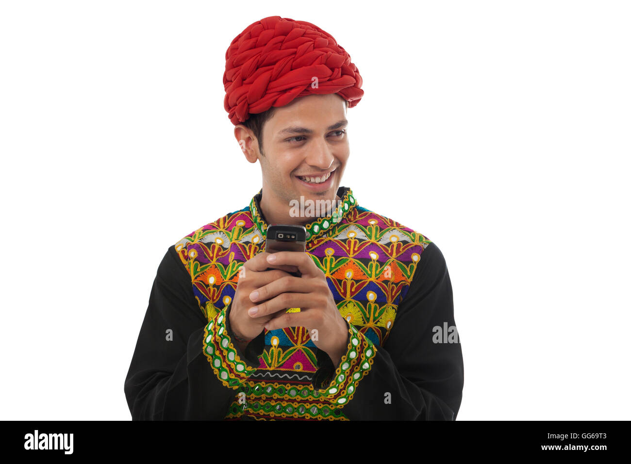 Male dandiya dancer with a mobile phone Stock Photo - Alamy