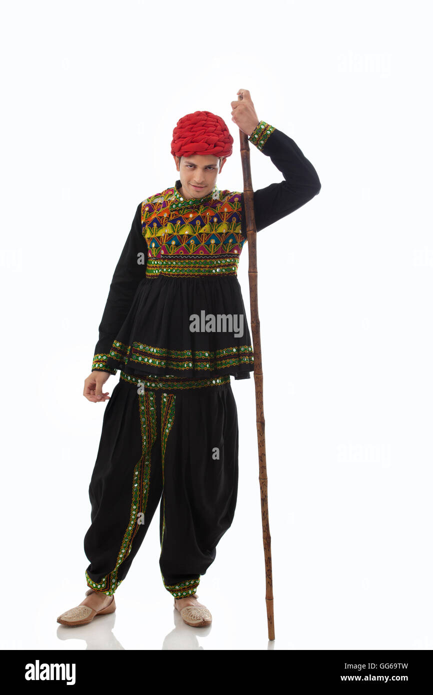 Portrait of a male dandiya dancer with a stick Stock Photo - Alamy