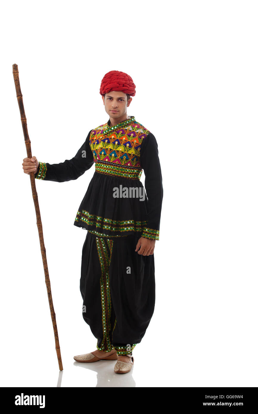 Portrait of a male dandiya dancer with a stick Stock Photo - Alamy