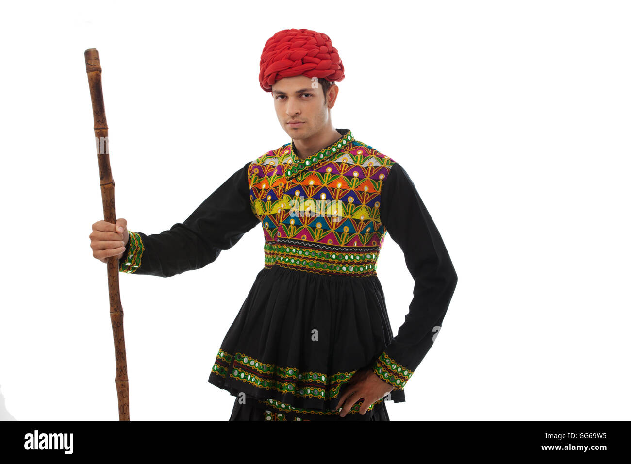 Portrait of a male dandiya dancer with a stick Stock Photo - Alamy