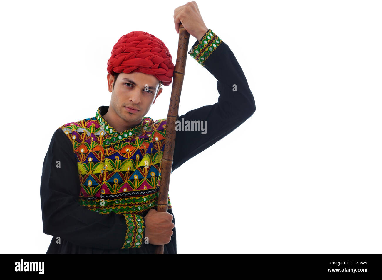 Portrait of a male dandiya dancer with a stick Stock Photo - Alamy