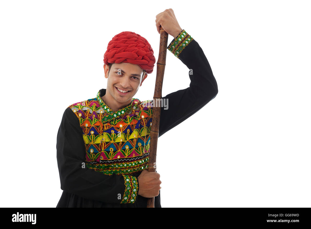 Portrait of a male dandiya dancer with a stick Stock Photo - Alamy