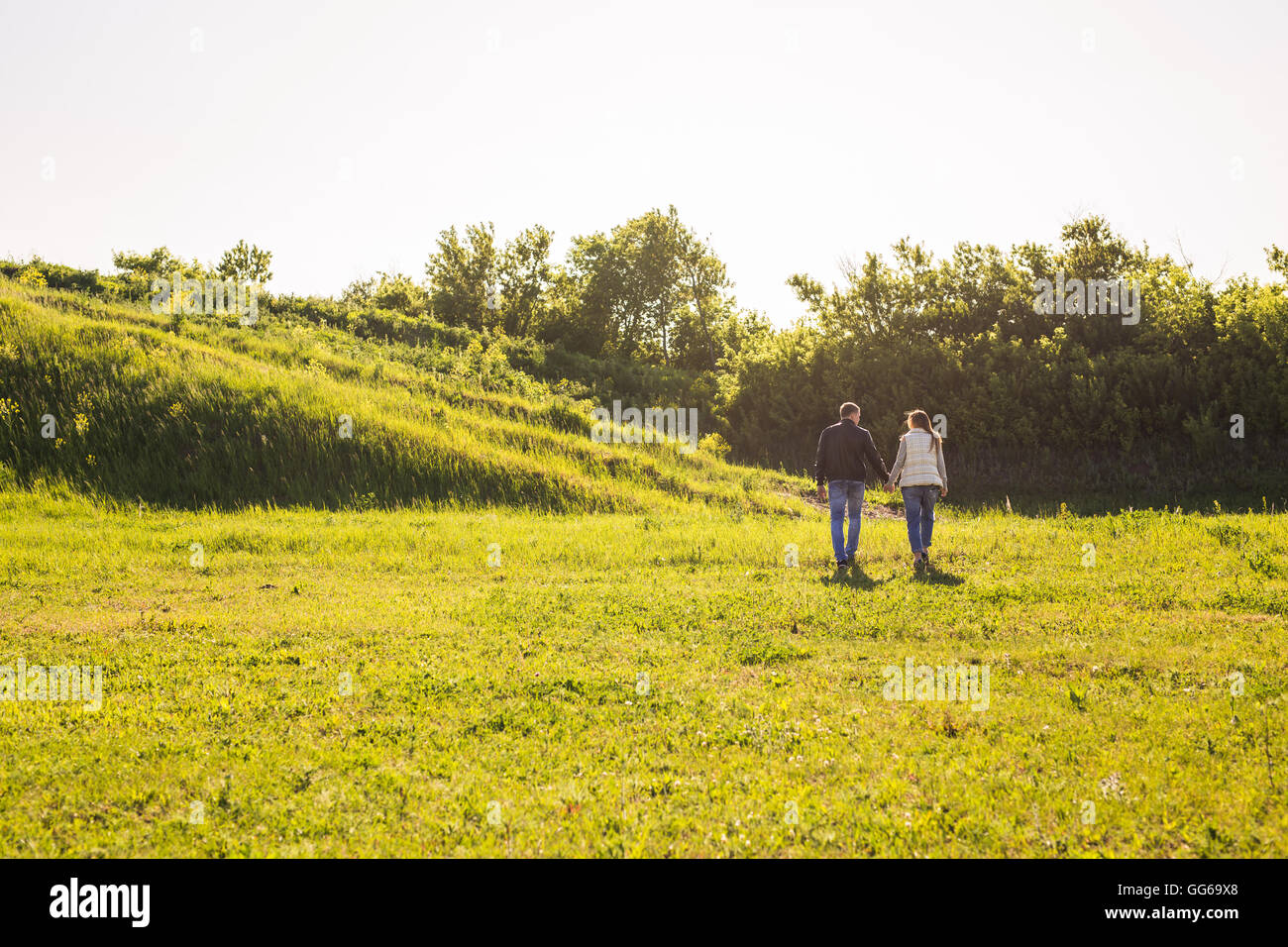 rear view of couple holding hands walking in autumn countryside Stock ...