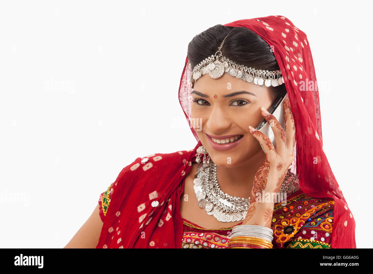 Female dandiya dancer talking on a mobile phone Stock Photo - Alamy