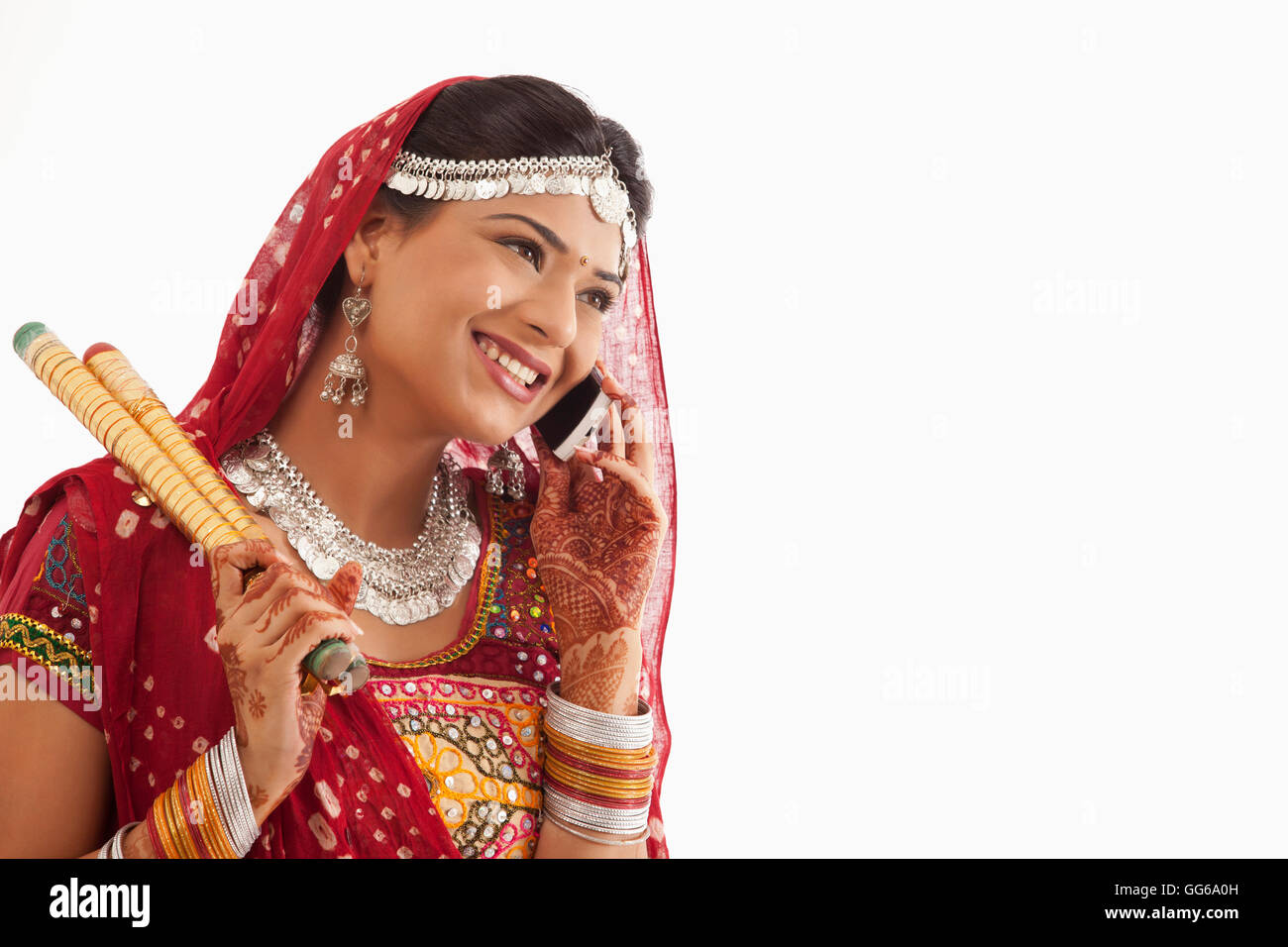 Female dandiya dancer talking on a mobile phone Stock Photo - Alamy