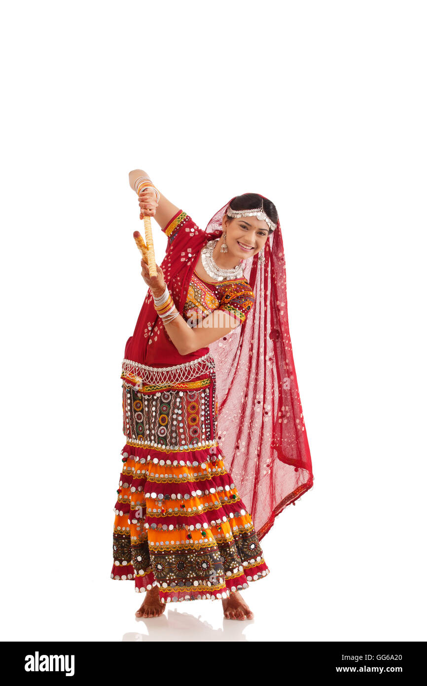 Female dandiya dancer dancing with sticks Stock Photo - Alamy