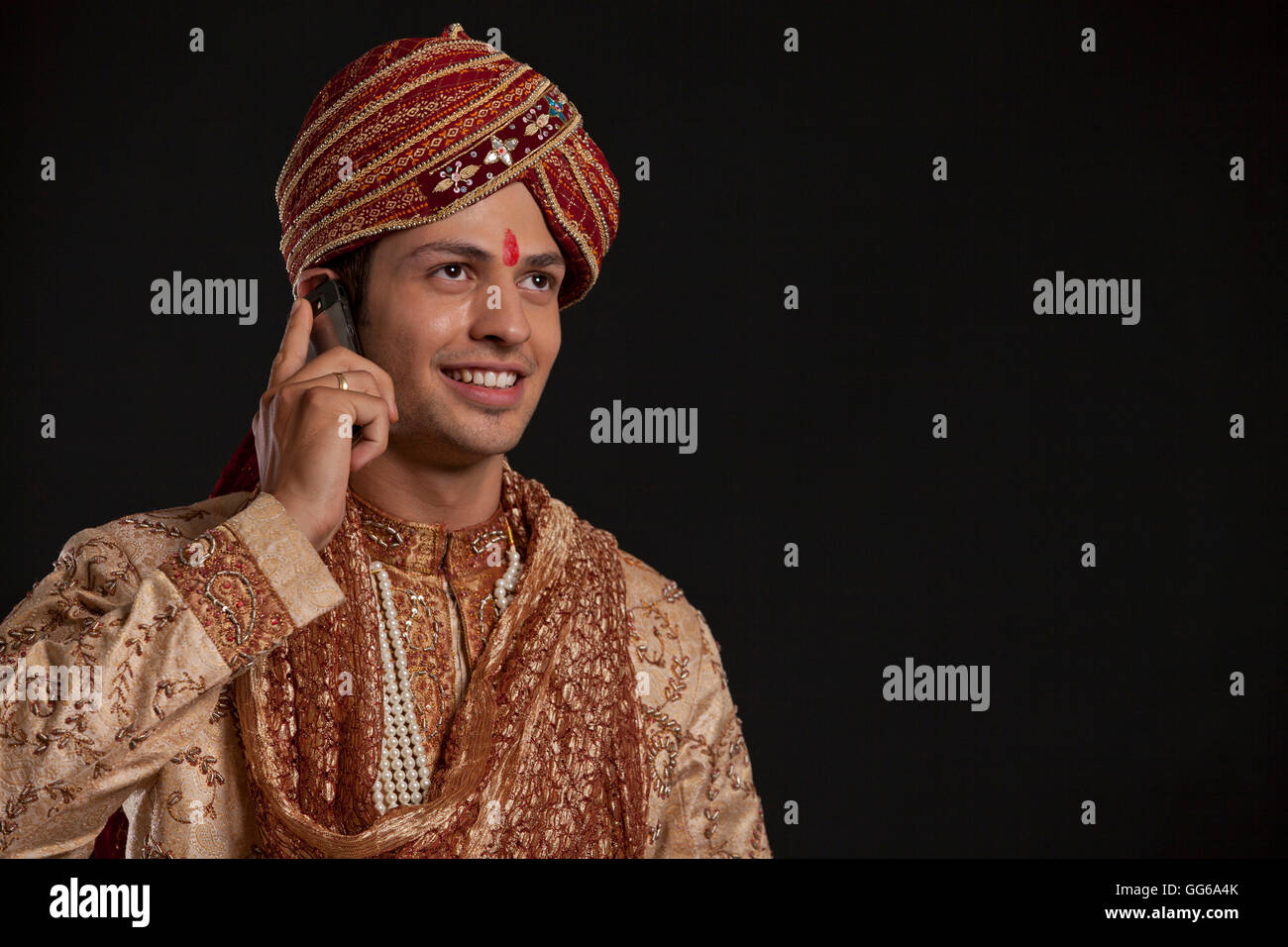 Gujarati groom talking on a mobile phone Stock Photo Alamy