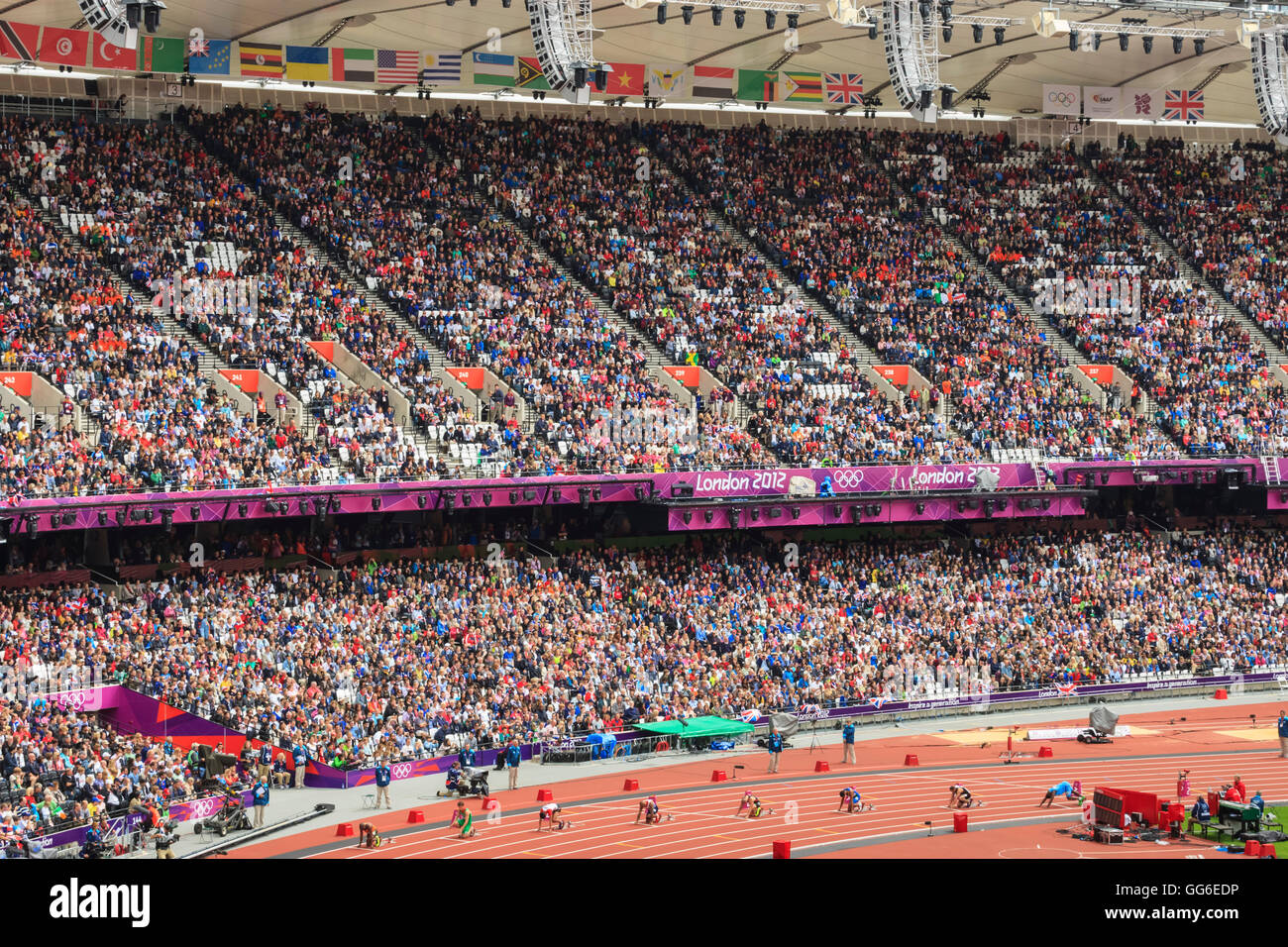 Crowds in the stands of Olympic Stadium, with runners on the starting