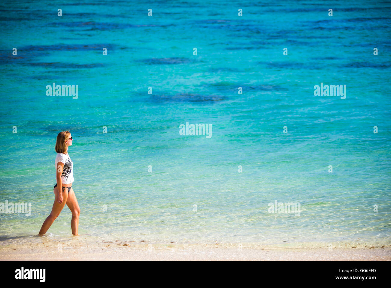 Woman walking along a tropical beach, Rarotonga Island, Cook Islands, South Pacific, Pacific Stock Photo