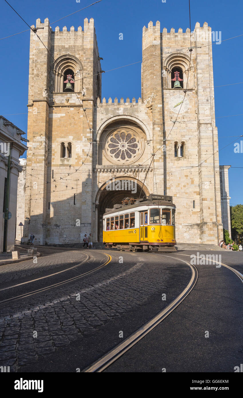The yellow tram number 28 close to the ancient Cathedral (Se), Alfama district, Lisbon, Portugal, Europe Stock Photo