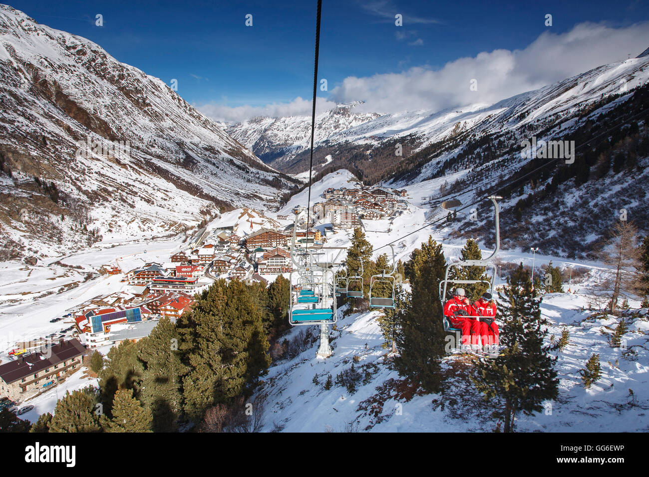 The village of Obergurgl, Otztal valley as skiers ascend the mountain on chairlifts, Tyrol, Austrian Alps, Austria Stock Photo